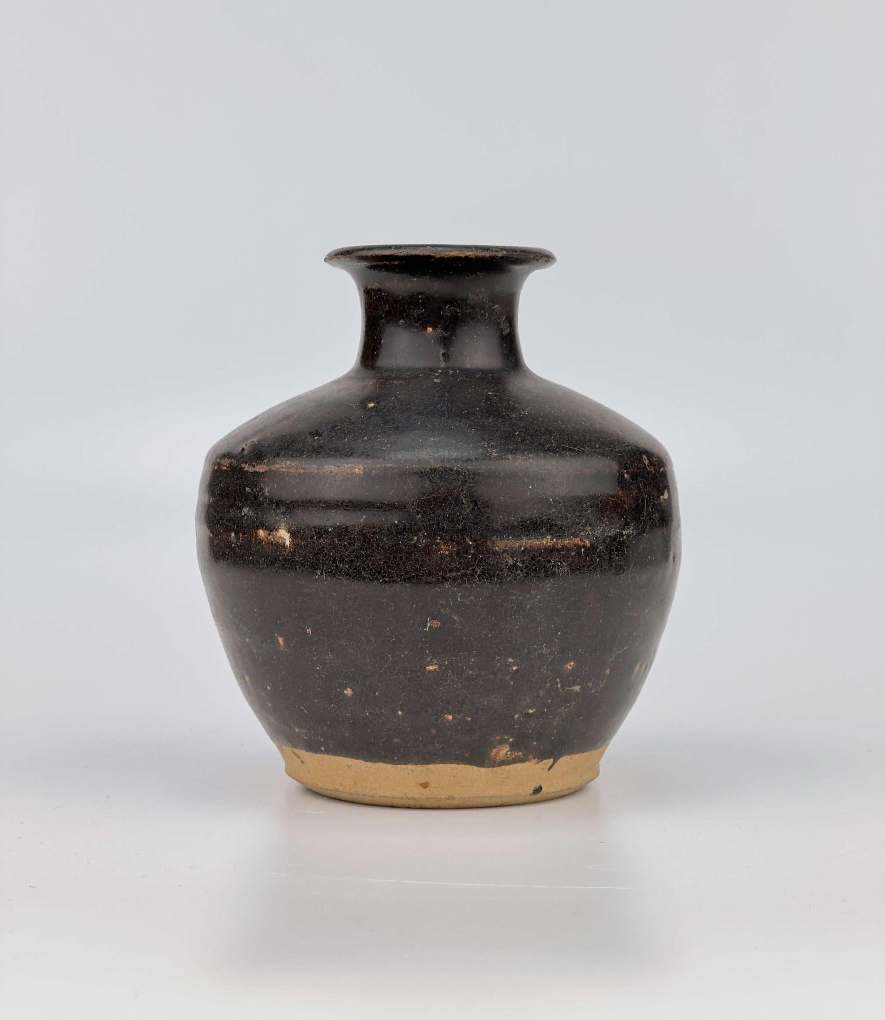 Black glazed bottle from the late Ming dynasty binh thuan cargo. An identical piece is included on page 146 of the Bin Thuan catalog titled 'The Age of Discovery: Asian Ceramics Found Along the Maritime Silk Road'.

Period: Ming Dynasty (16-17th