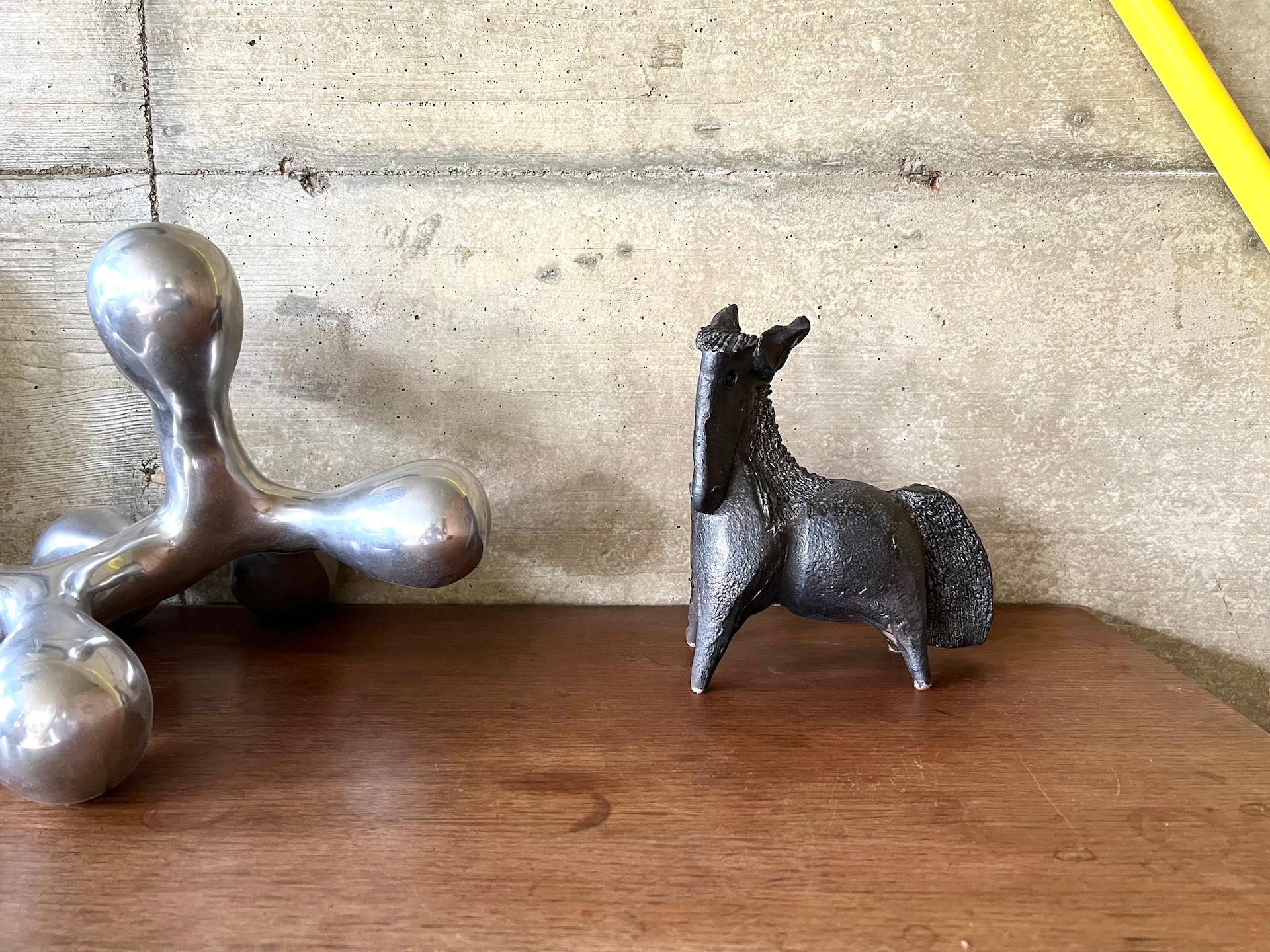Maison Lecan is pleased to present this rare and striking ceramic sculpture of a stylized horse, signed “Pouchain” on the underside.


Crafted in the 1960s, this piece is a fine example of Robert Pouchain’s most expressive work, made during his time