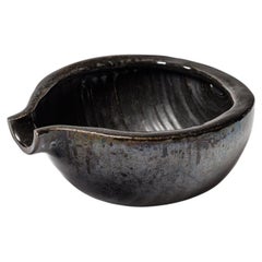 Black glazed ceramic pouring bowl by Accolay, circa 1960-1970.
