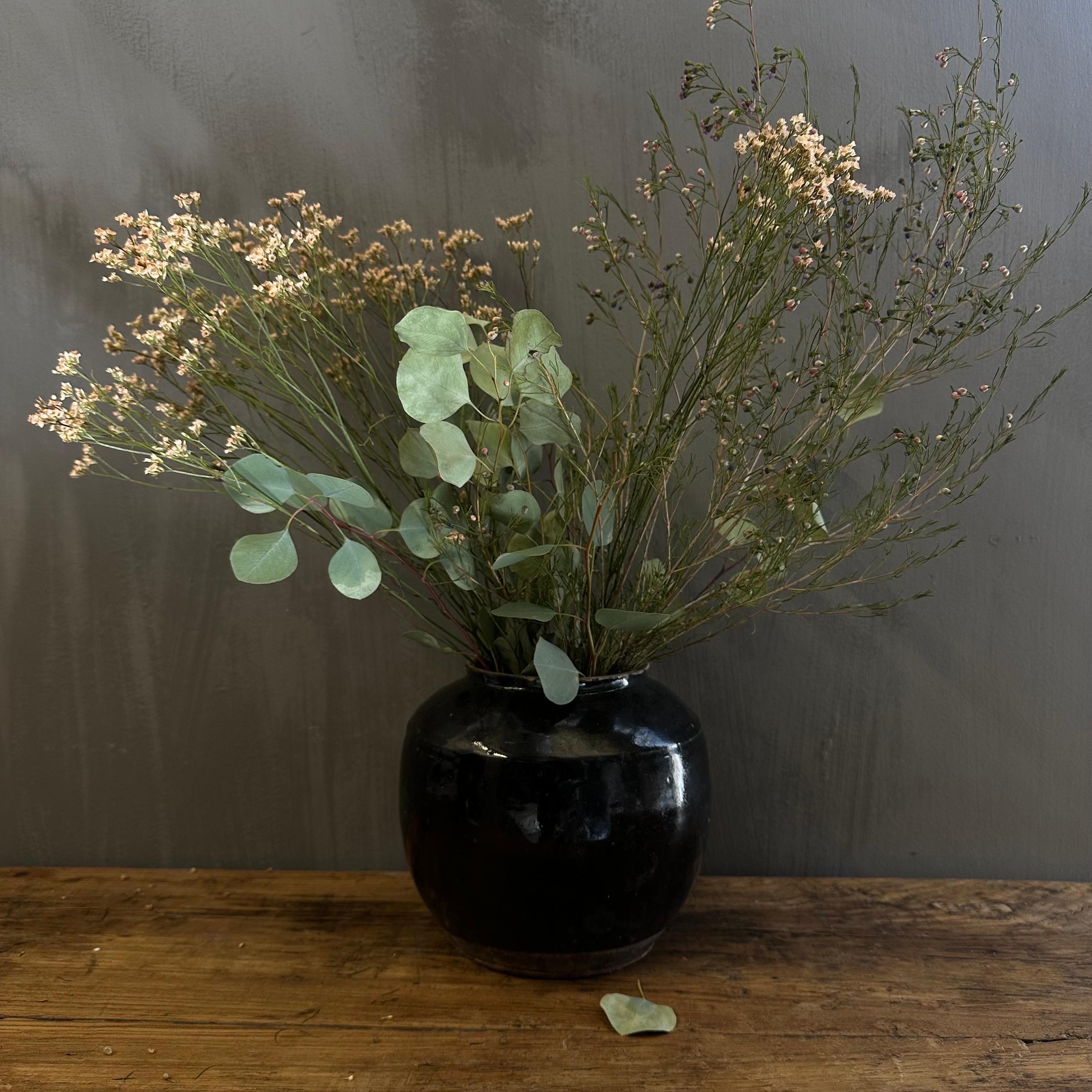 Vintage pottery beautiful and rich in character, this vintage oil pot adds just the right amount of texture + warmth where you need it. Stunning glazed black finish with warm terra-cotta accents. Some have a more faded appearance than others, each