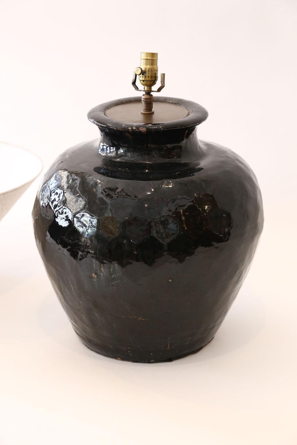Black glazed terracotta table lamp, newly wired for use within the USA. Custom lamp from vintage Asian ceramic vase glazed in a iridescent black. Nice large proportions. Includes complementary custom coolie-shape Belgian linen shade (measurements
