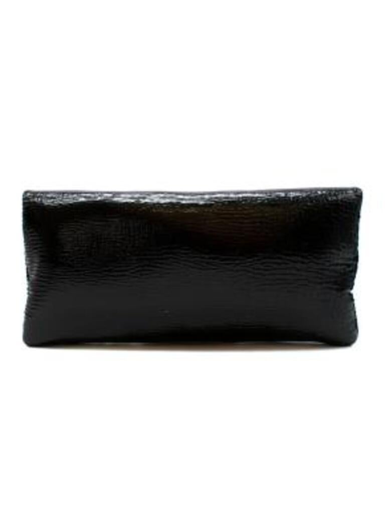 Bvlgari Black Glossy Monete Foldover Clutch
 
 -Gold-tone hardware
 -Satin interior
 -Single zip pocket at interior wall 
 -Magnetic closure at foldover flap 
 -Detailed with a distinct charm at the front
 
 Material: 
 
 Patent Leather 
 
 Made in