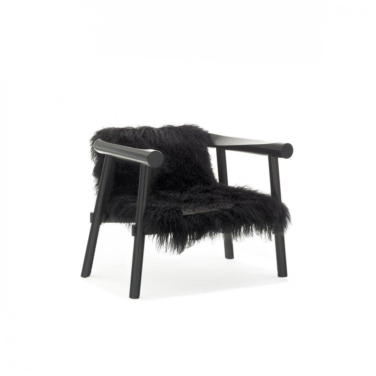 Black Goatskin Altay armchair by Patricia Urquiola
Materials: Black lacquered solid beech structure. Seat covered with black Mongolian goatskin.
Technique: Lacquered and stained wood. Upholstered in natural skin. 
Dimensions: D 73 x W 73 x H 63