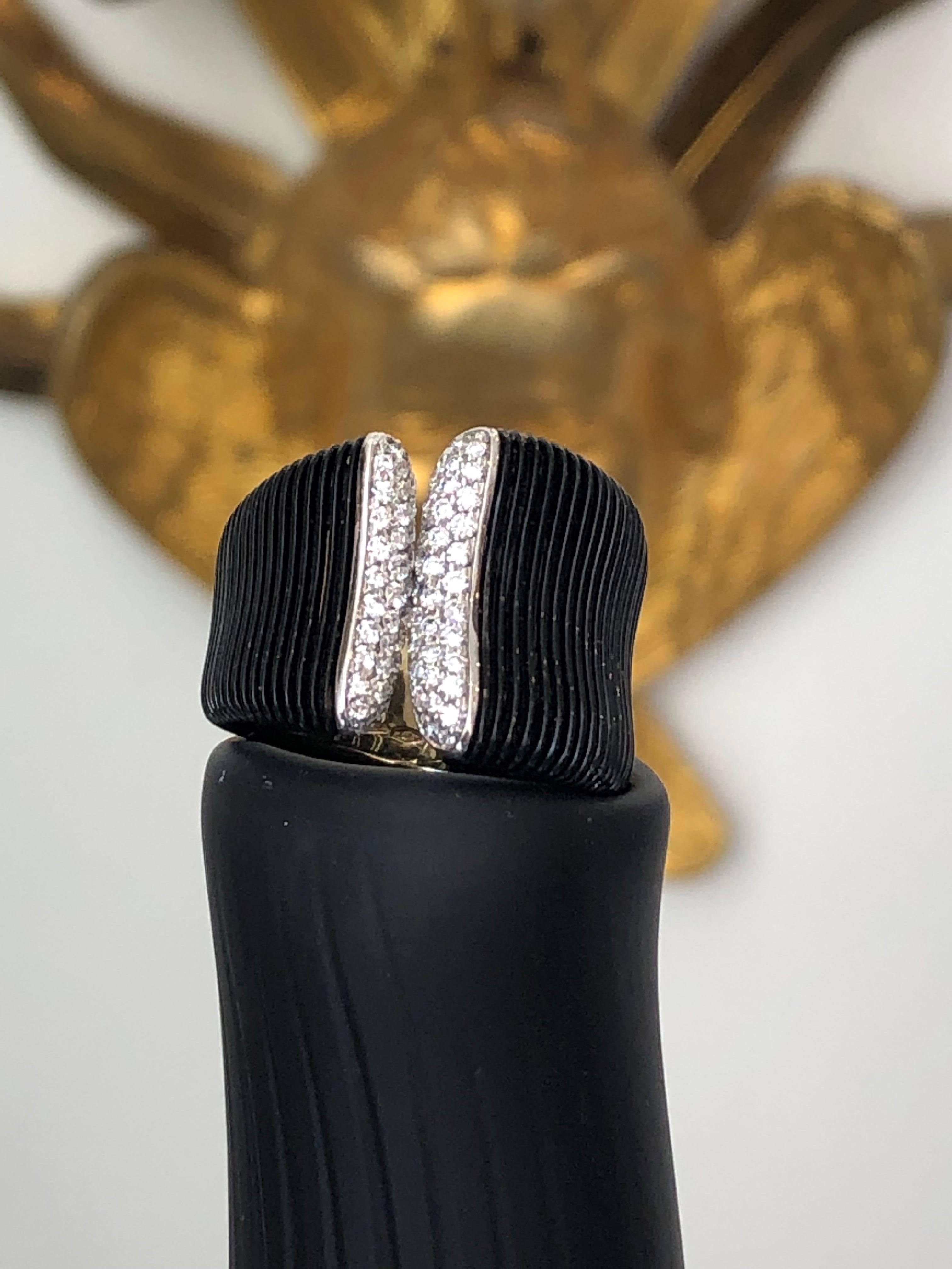 Black Gold and Diamond Band Ring containing .56 carats of Brilliant Round Cut Diamonds, all F-G color and VS clarity, set into black rhodium plated 18 karat White gold.  Rhodium is a precious metal that is in the family of platinum, that safeguards