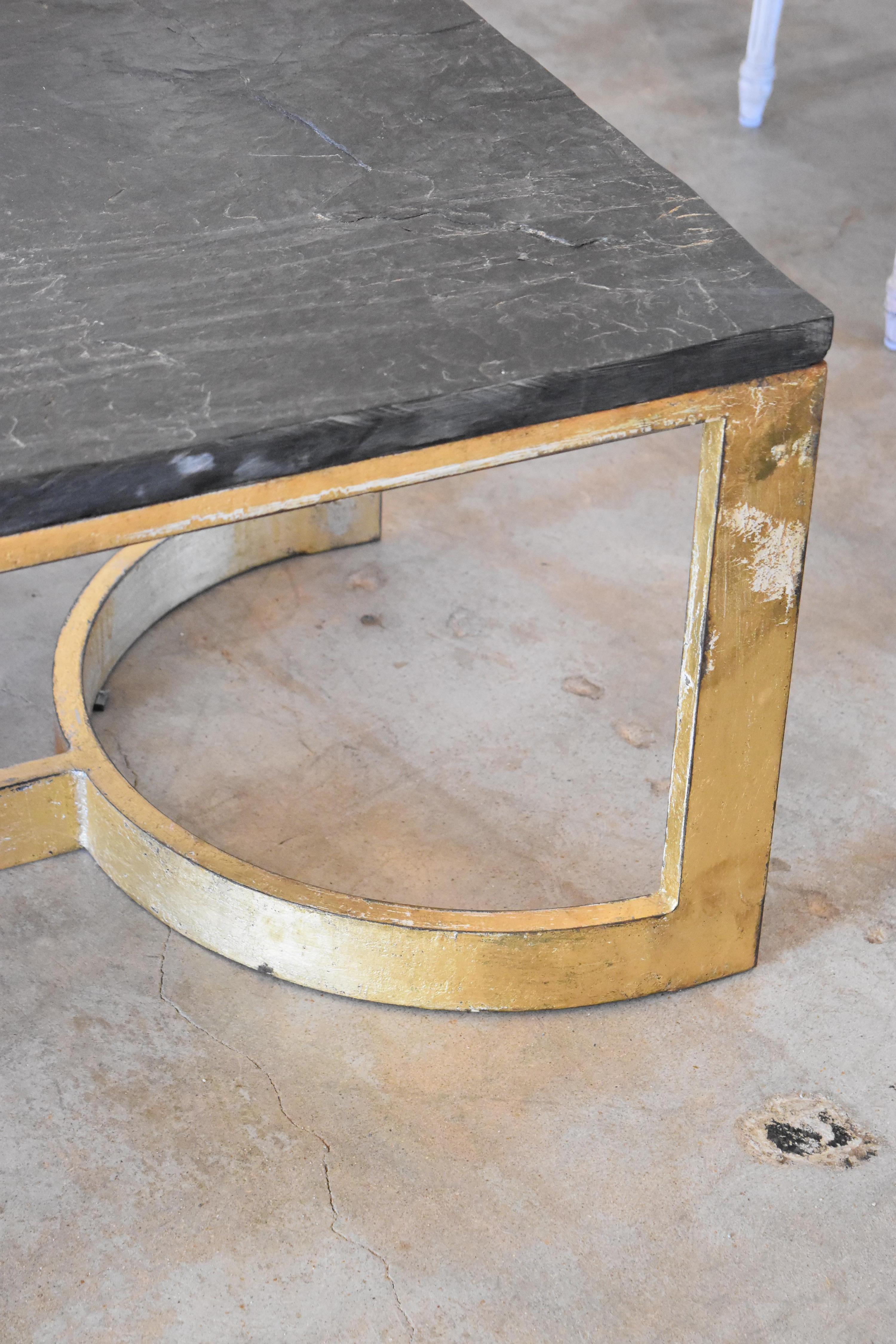 This is a very heavy duty table made by our own artisans in Europe out of steel, fitted with slate top and gilt. It's meant to look vintage and not perfect so there will be scratches and imperfections.