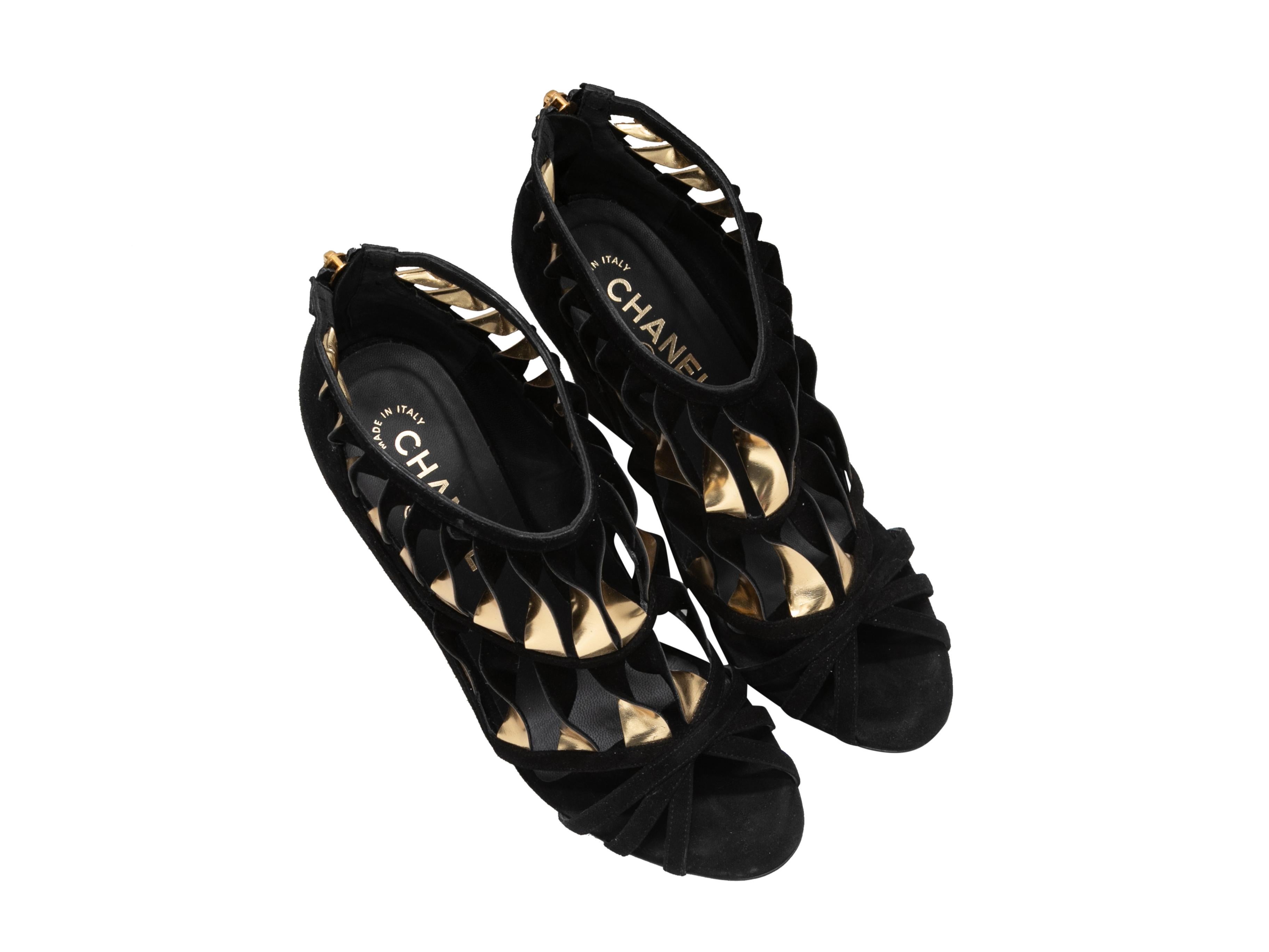 Black and gold suede and leather cutout wedge heeled sandals by Chanel. Covered heels. Zip closures at counters. 4.25