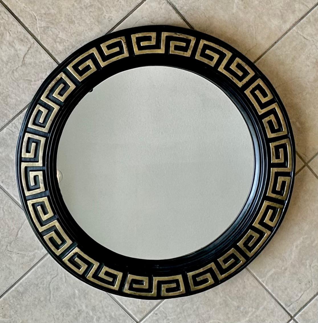Great mid-century black painted wall mirror with gold Greek key detailing. The unique construction is done in a molded (hollow) fiberglass composite. 