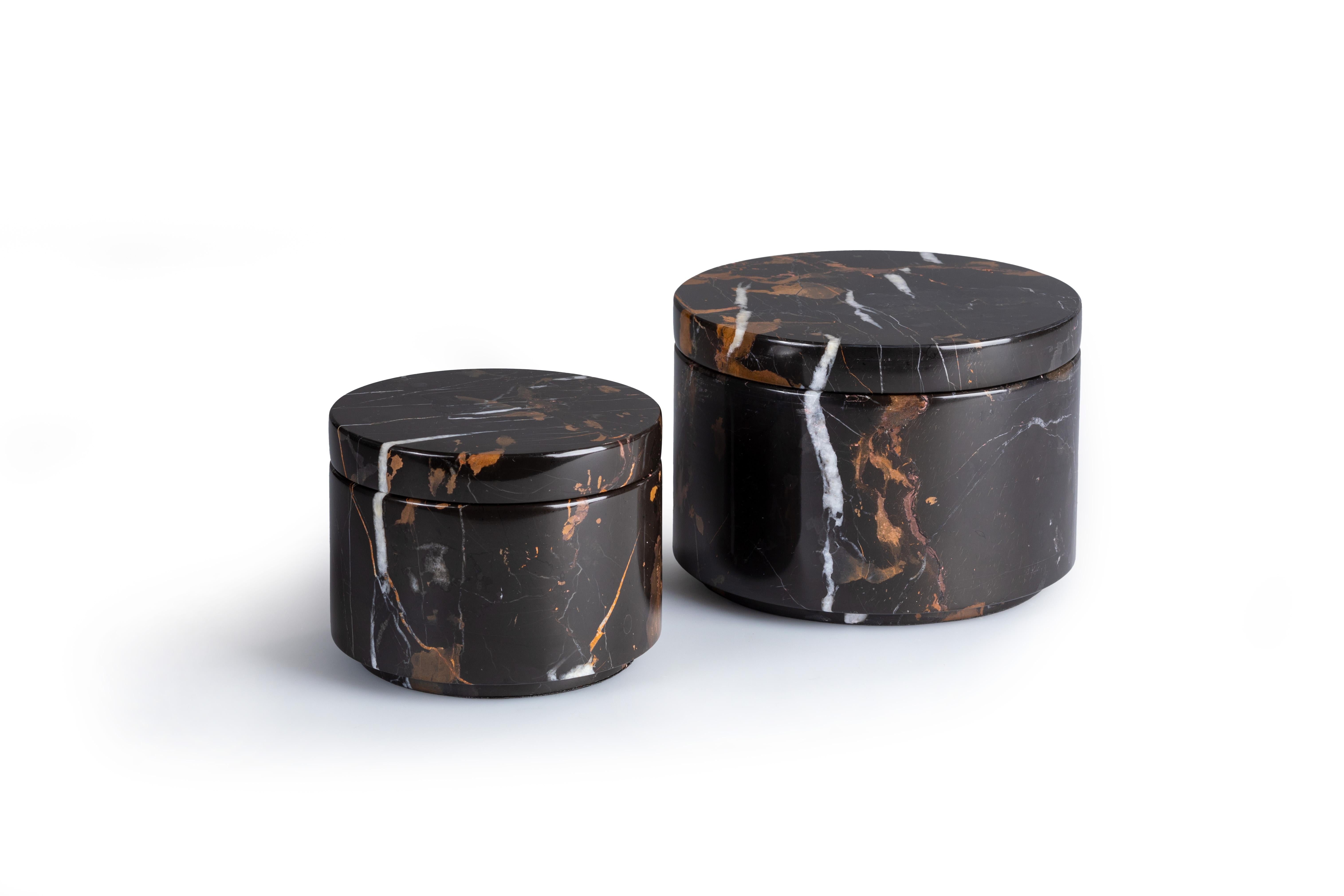 This handcrafted decorative container set includes two cylindrical containers with removable lids, each featuring a polished black surface with unique white-gold veins. Perfect for showcasing in any room, these versatile containers add a touch of