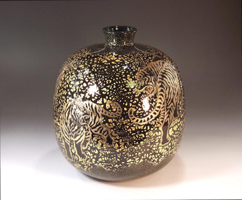 Exquisite contemporary decorative porcelain vase, intricately hand painted in gold on a stunningly shaped ovoid body in black to create a transparent surface, The signed work of widely admired master artist from the historic Imari-Arita region of