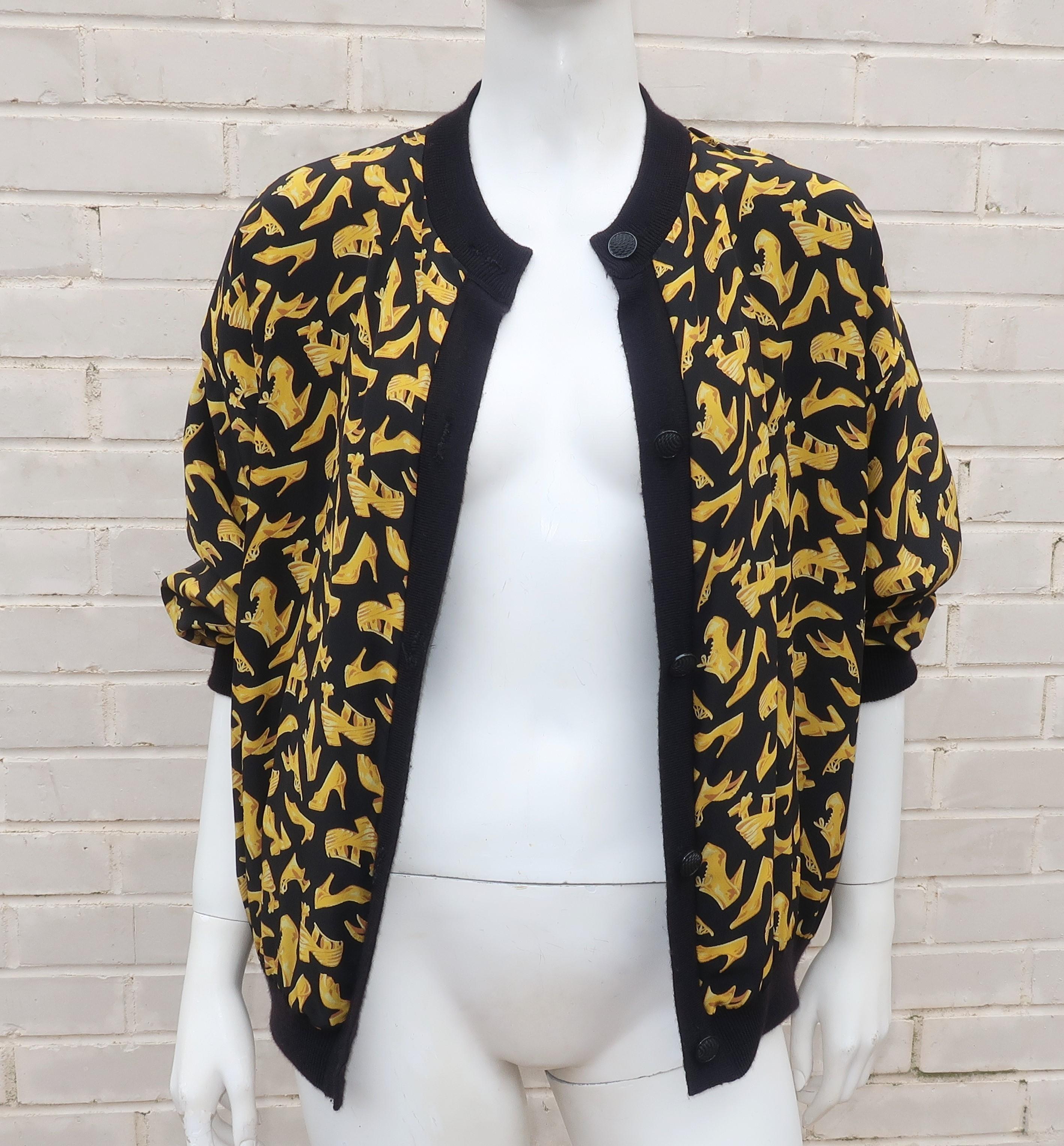 A whimsical reversible sweater with a black and golden yellow silk shoe print on one side and a soft wool sweater on the other.  Wear it with the print as a liner for a simple black topper or reverse it for something more fun.  Constructed with faux