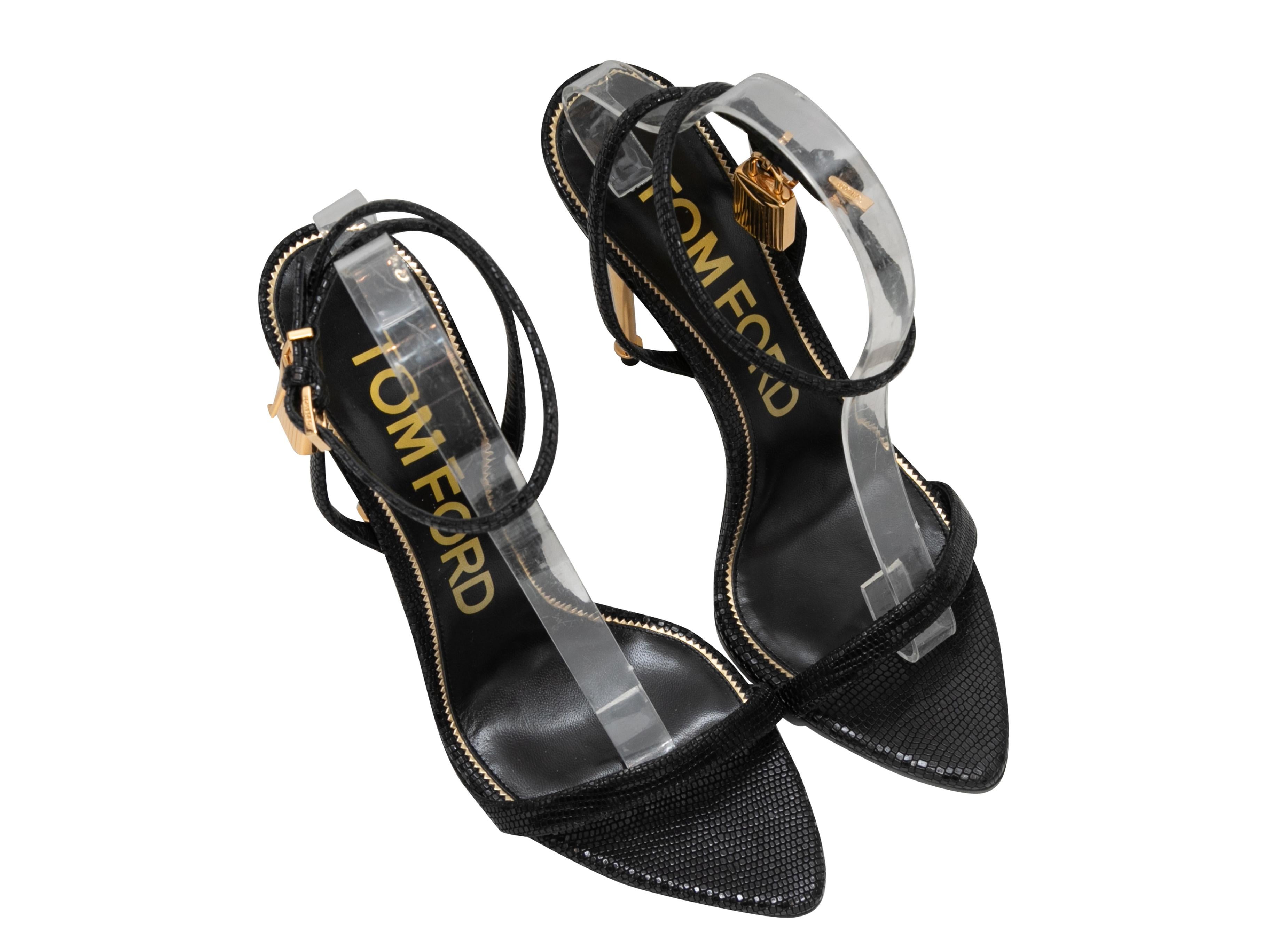 Product Details: Black lizard Padlock heeled sandals by Tom Ford. Gold heels. Buckle closures at ankle straps. 4