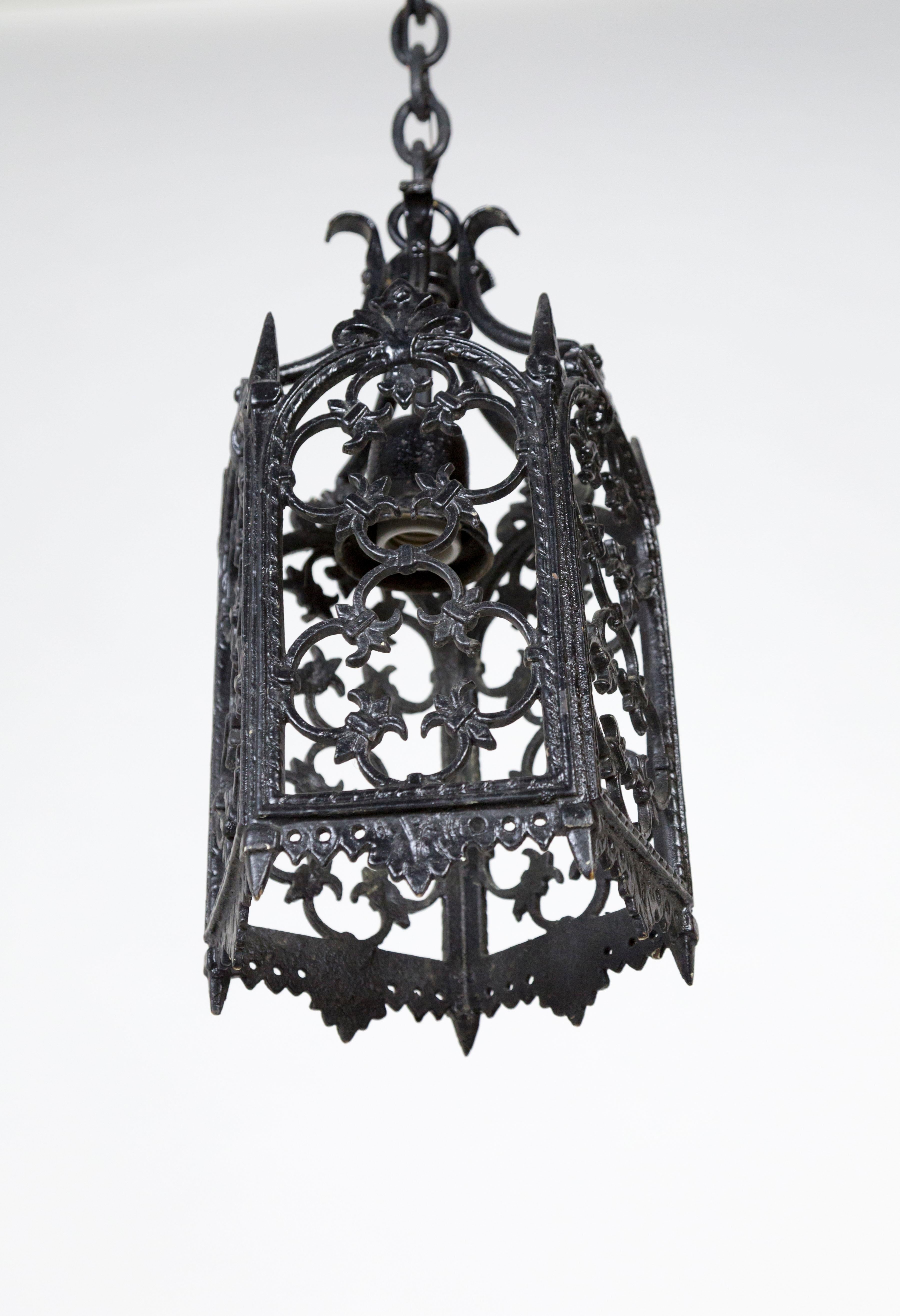 A petite, five-sided, Gothic style, wrought iron, black painted lantern. Midcentury. Medium socket, newly rewired. Measures: 15