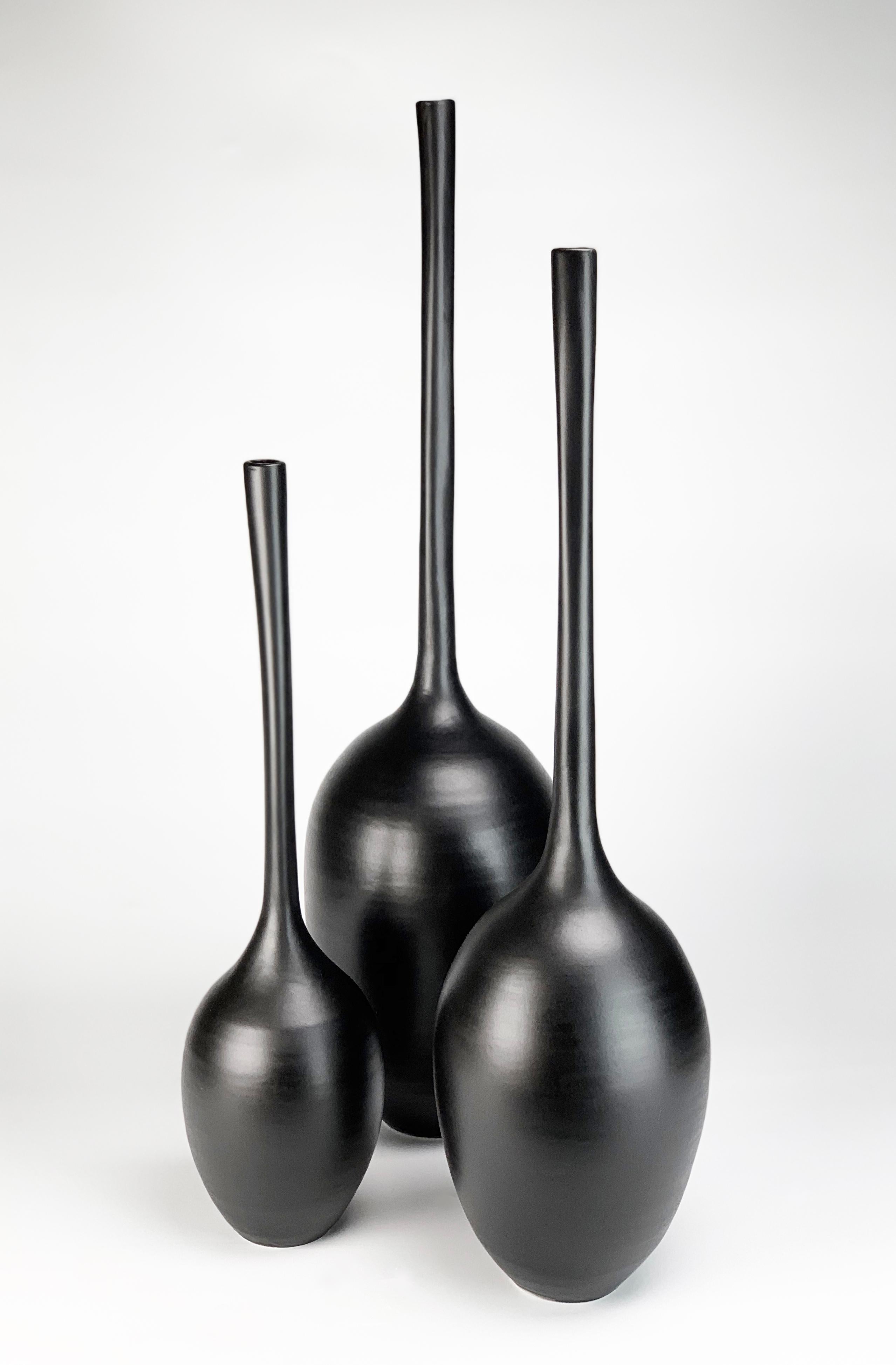 Set of 3 black ceramic gourd sculptures by Michael Boroniec - ceramic, glaze  

Dimensions: (approx.)
Left. 21.5 x 6 x 6 in 
Center. 24.5 x 6.5 x 6.5 in 
Right: 23 x 5.25 x 5.25 in  

Michael Boroniec’s 