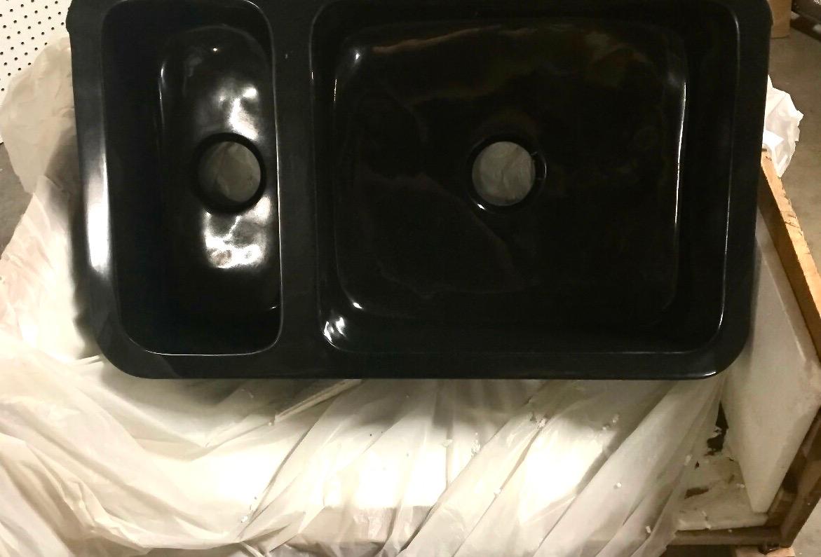 Black granite hand carved farmhouse sink, double basin, two-sided, polished, New. Custom ordered, hand carved, can be positioned with the hand carved or smooth burnished front.
Measures: Overall (exterior) 33.25 x 20.5 x 10.25 inches
Basin 1