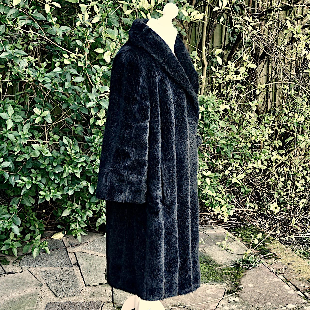 Wonderful black Grevelour Princesse faux fur coat, with three quarter length sleeves and a large faux fur button closure. It is fully lined with black satin, and has a ribbon and loop to hold the closed coat in place. There are two side pockets. The