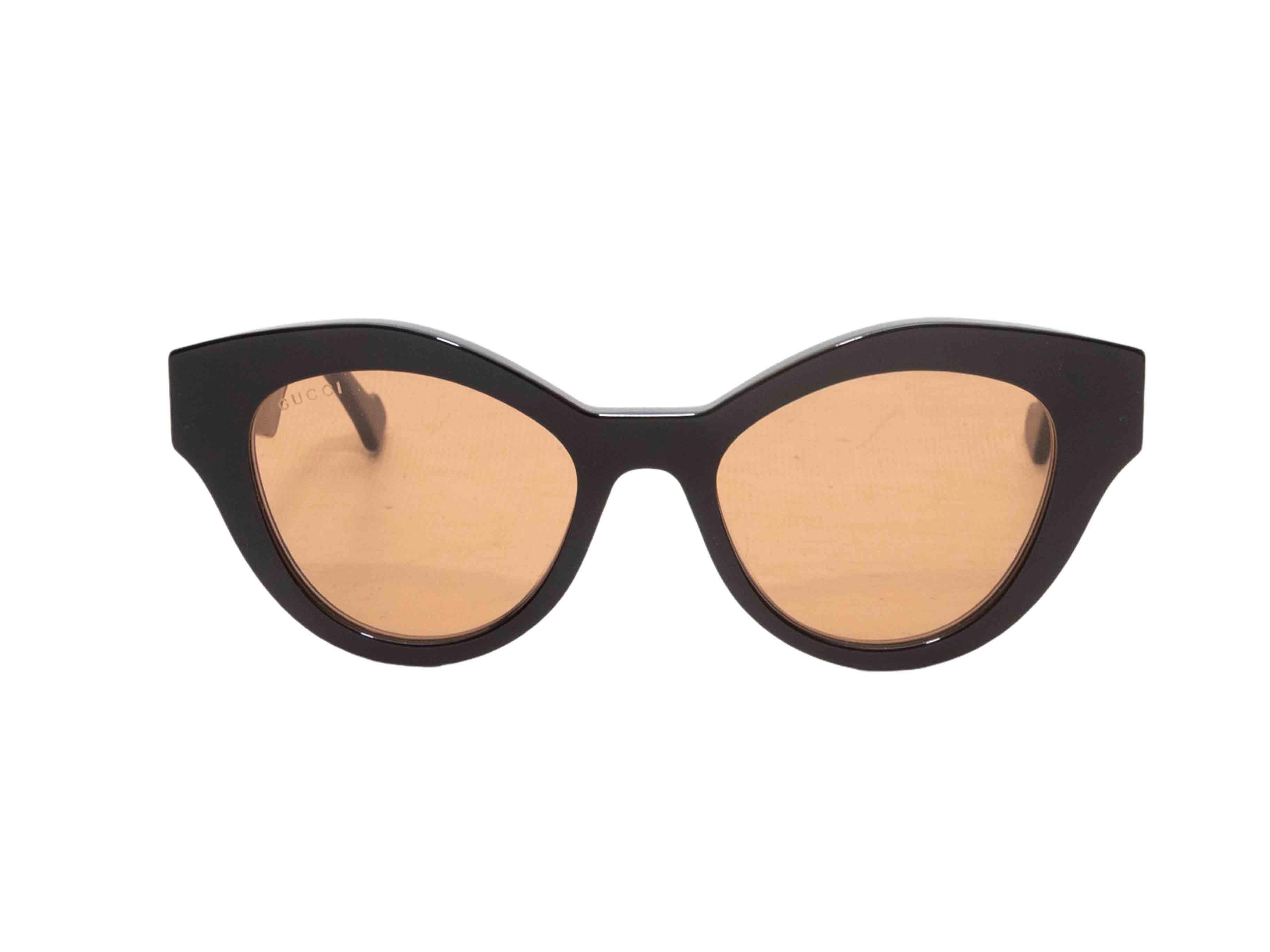 Occhiali da sole cat-eye in acetato nero di Gucci. Lenti colorate arancioni. Altezza 2