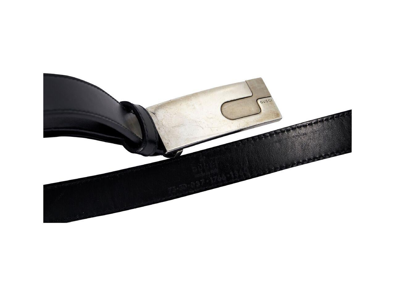 Product details:  Black leather belt by Gucci.  Adjustable buckle closure.  Antiqued silvertone hardware.  35