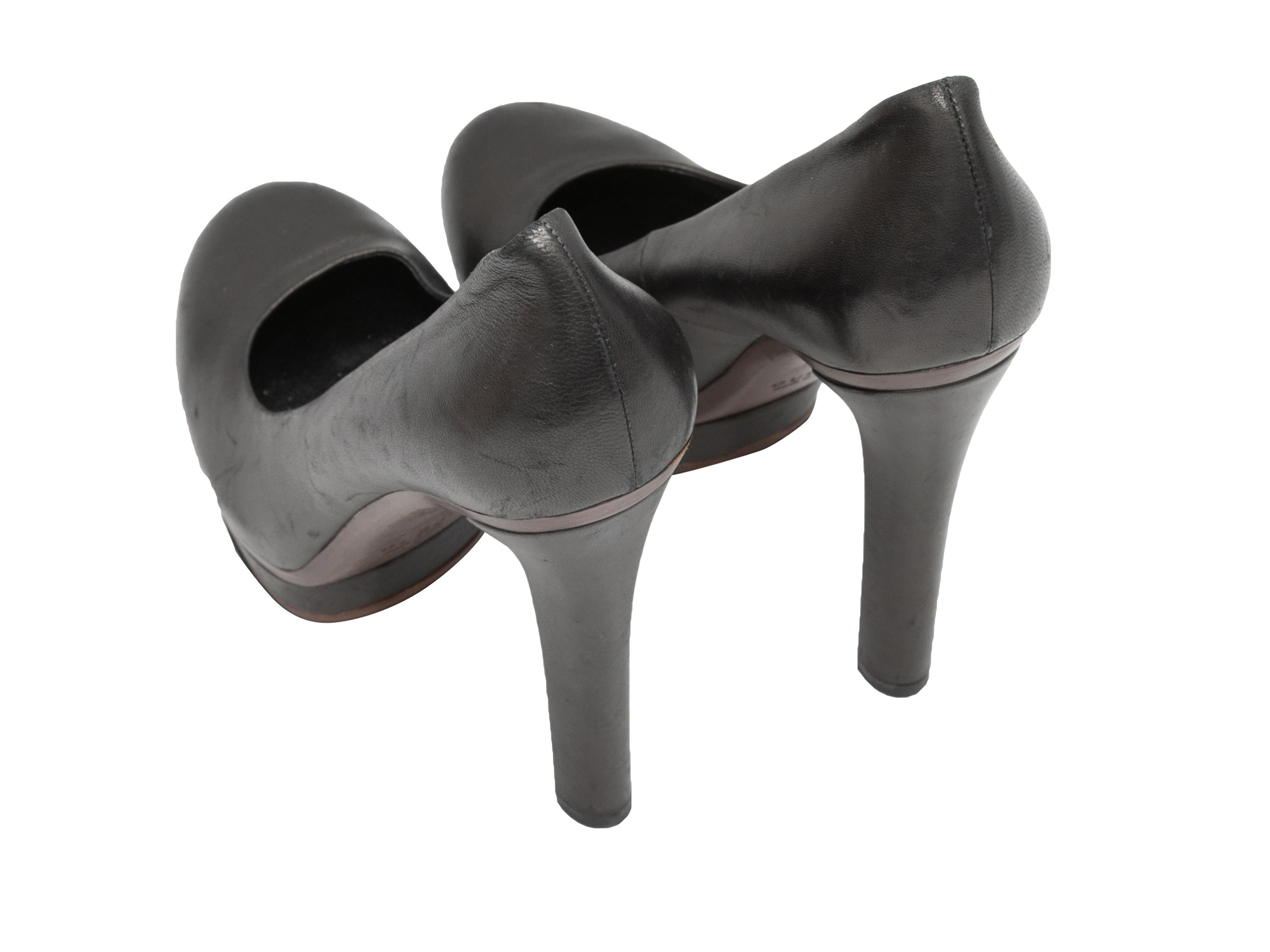 Black leather round-toe platform pumps by Gucci. 1