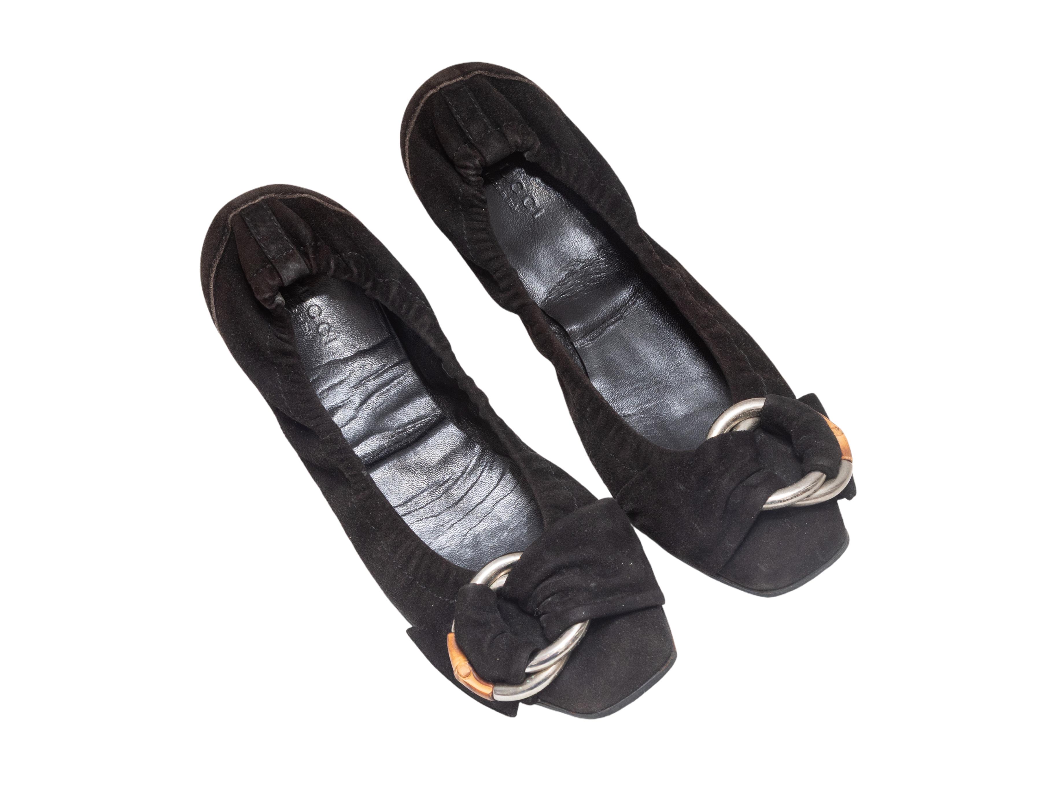 Black suede ballet flats by Gucci. Bamboo buckle accents at tops. 0.5