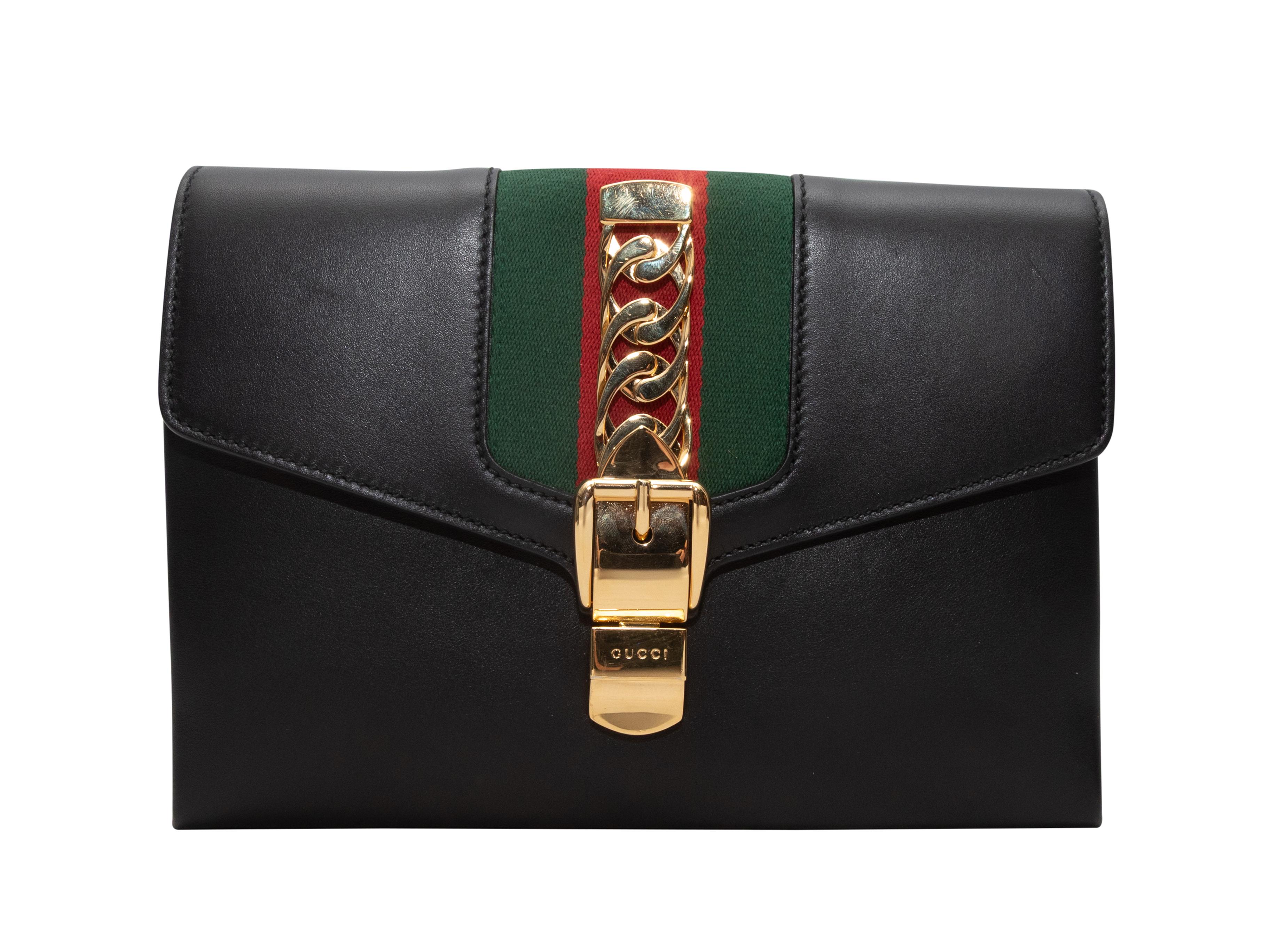 Black Gucci Sylvia Web-Trimmed Leather Clutch. The Sylvie clutch features a leather body, Web trim, gold-tone hardware, and front buckle closure. 10