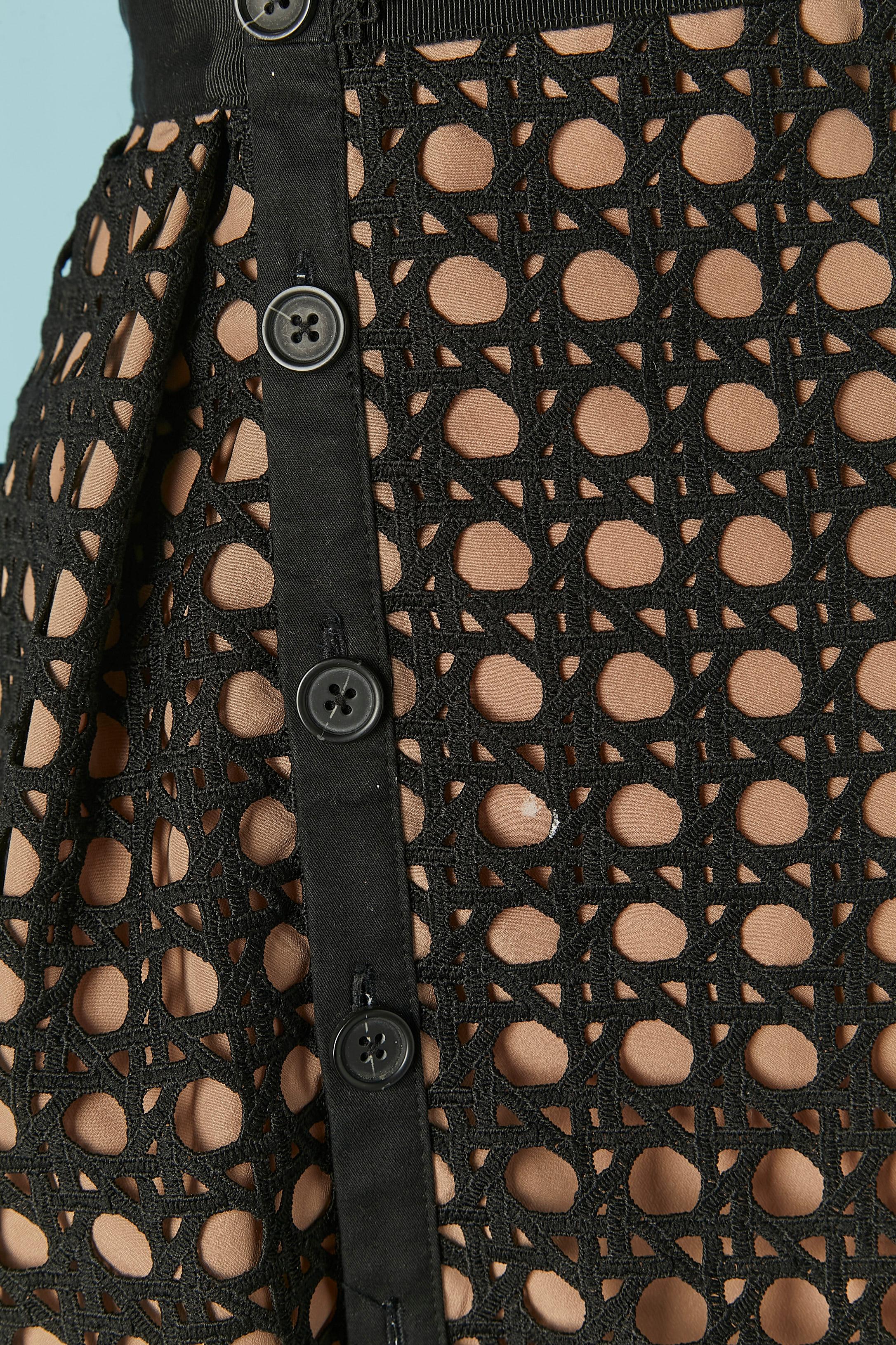 Black guipure cocktail dress. Main fabric composition: 100% polyester. Trim ( on the waist ) 100% cotton. Sheer lining composition: 100% polyester. Asymmetrical button placket.      Button and buttonhole closure on the middle front. Zip and hook&eye