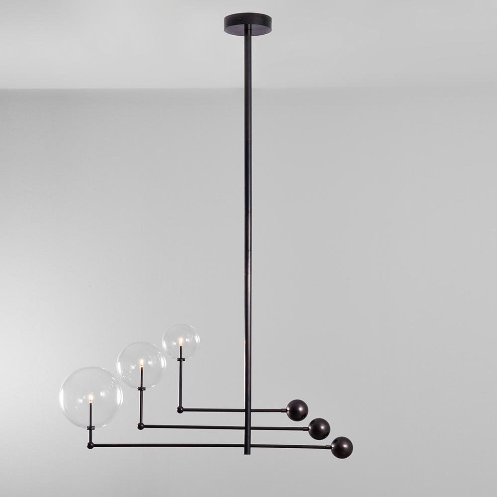 Black gunmetal 3 arm contemporary chandelier by Schwung 
Dimensions: D 25 x W 128.2 x H 178 cm 
Materials: solid brass, hand-blown glass globes
Finish: black gunmetal. 
Also available in finishes: polished nickel or natural brass.
All our lamps