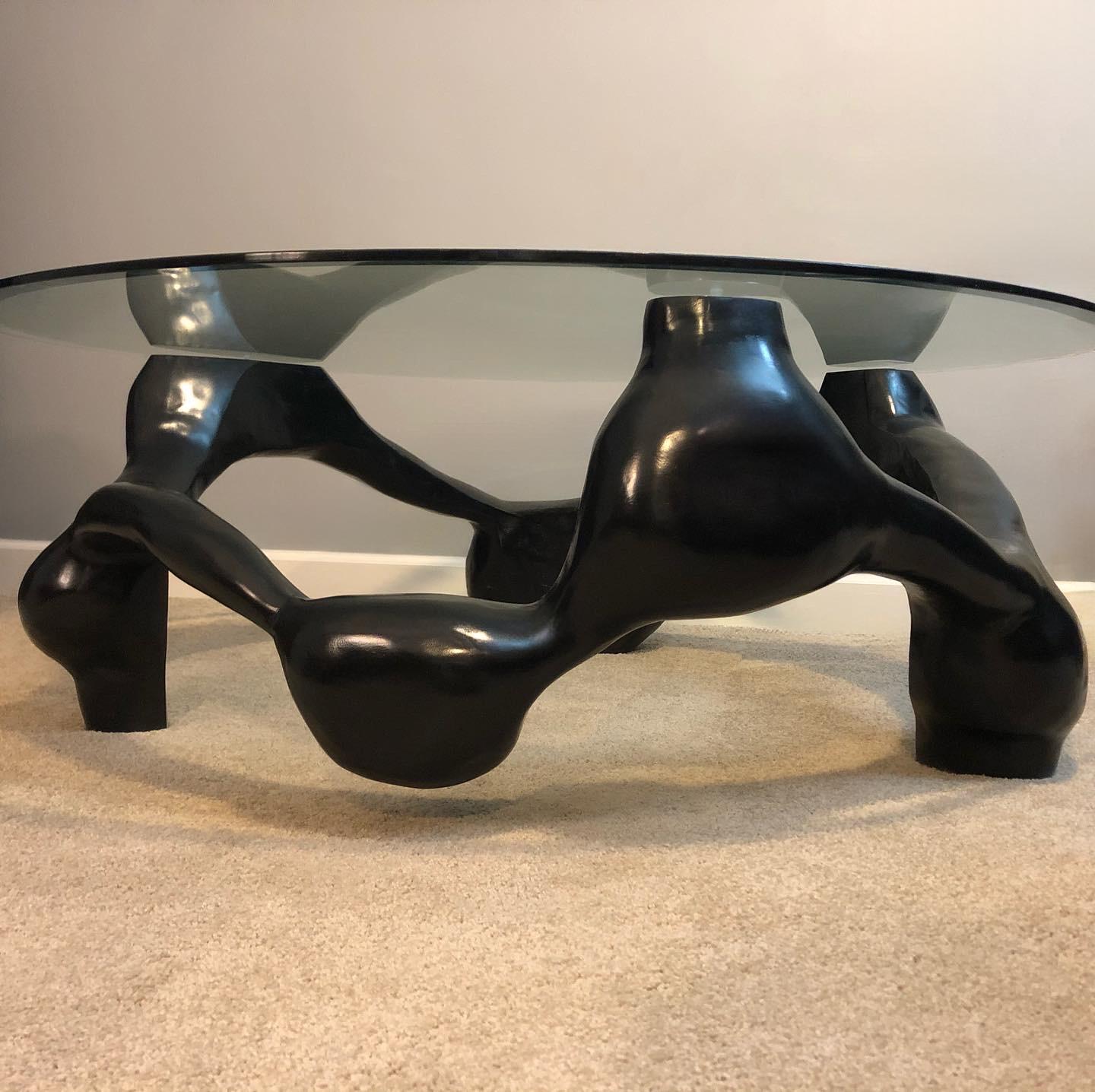 This modern hand-carved coffee table is made from local poplar sanded smooth and colored with ebony stain. It is a designed as a centerpiece and work of art. Its organic form fits into any modern setting. Approximately 50 hours of craftmanship went