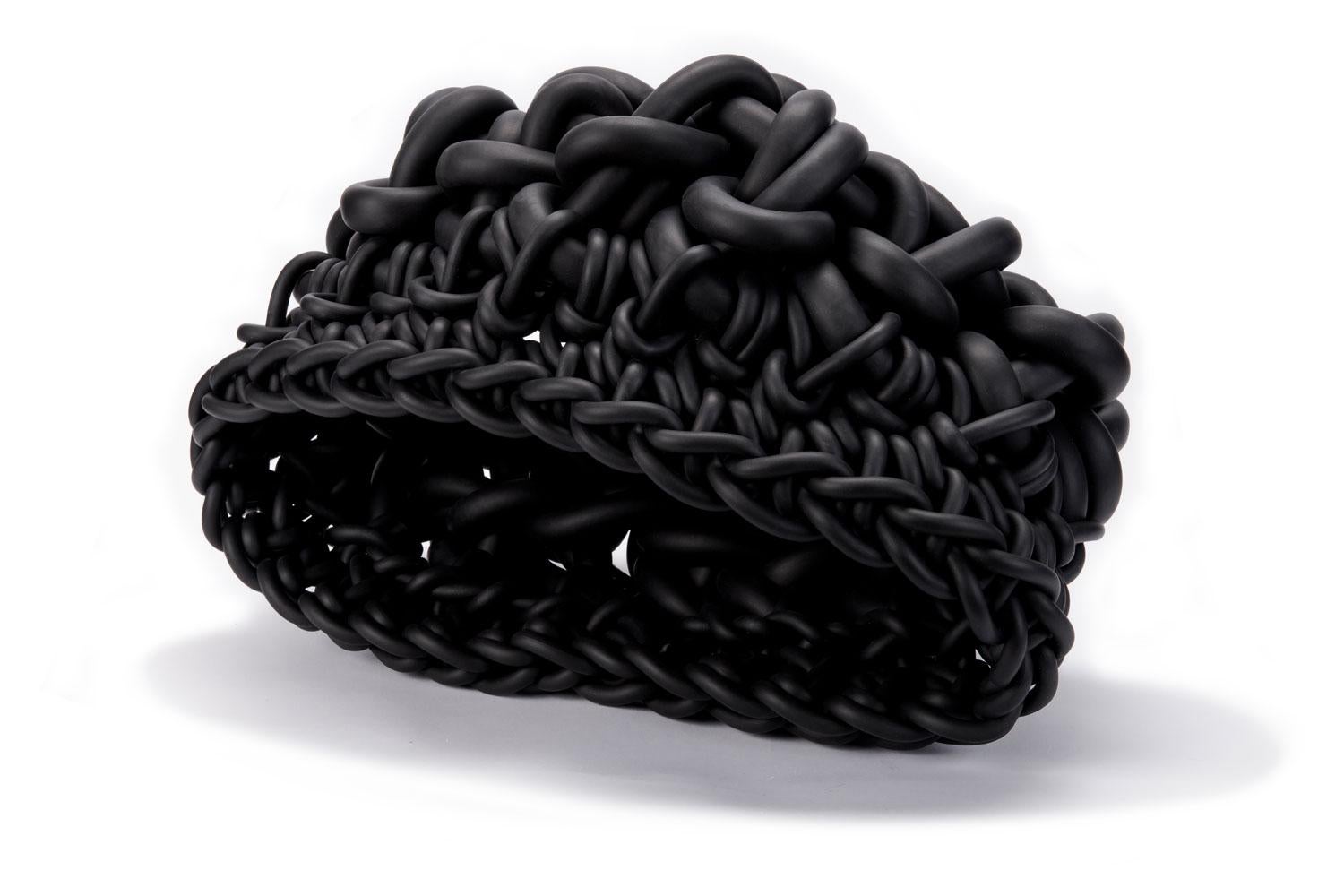 Hand-knitted in Italy, this black colored neoprene basket is designed by Rosanna Contadini. Neoprene is strong and resistant and has great elasticity. Each basket is unique in shape, color, size and weaves and works well in a variety of interiors.