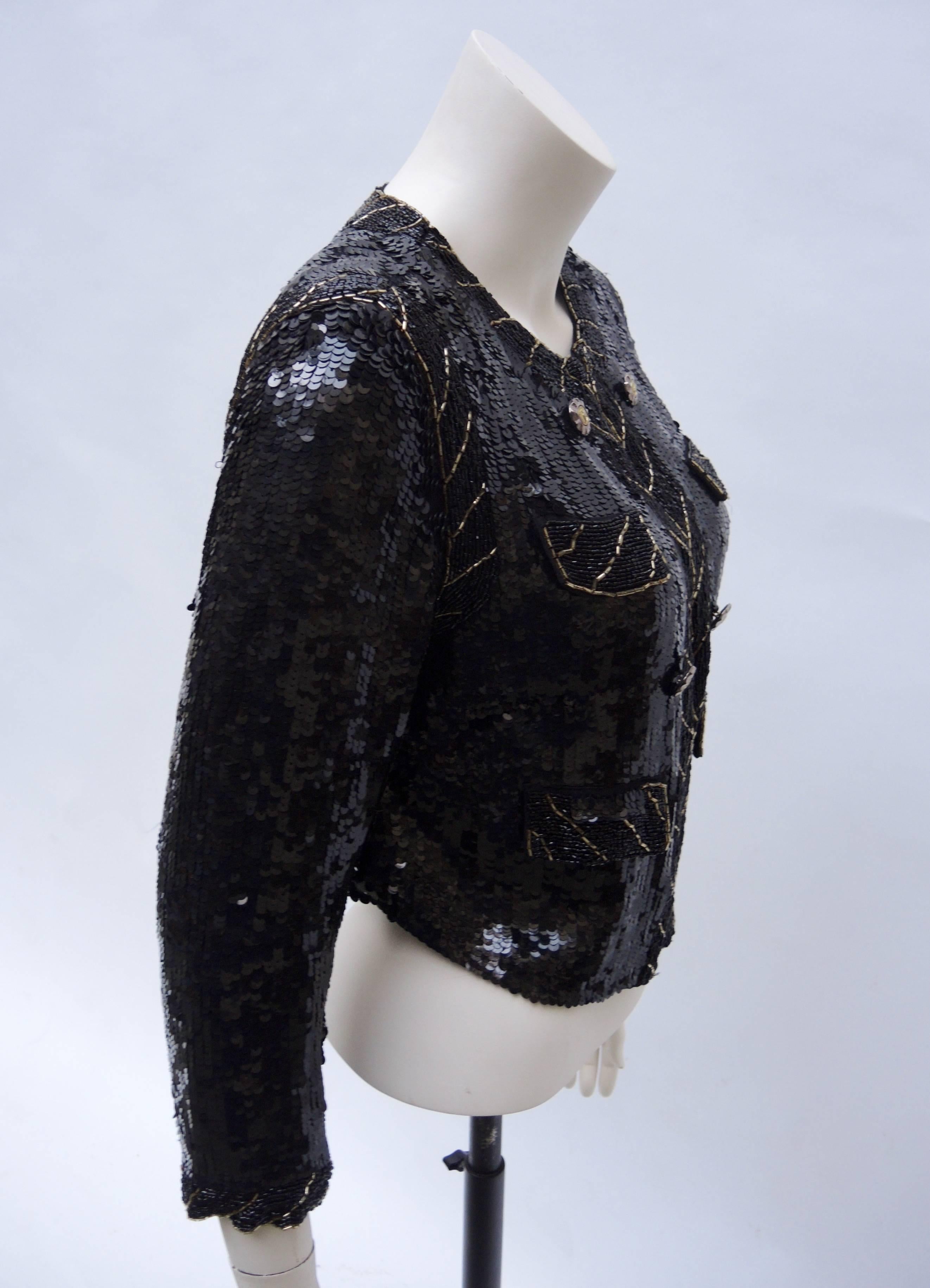 Fantastic vintage black hand  sequinned jacket trimmed with gold and black bugle beads. 
The elegant silhouette; shorter in the back is very slimming and the Invisible black hook closure is made so the jacket can be worn open or closed. Great worn