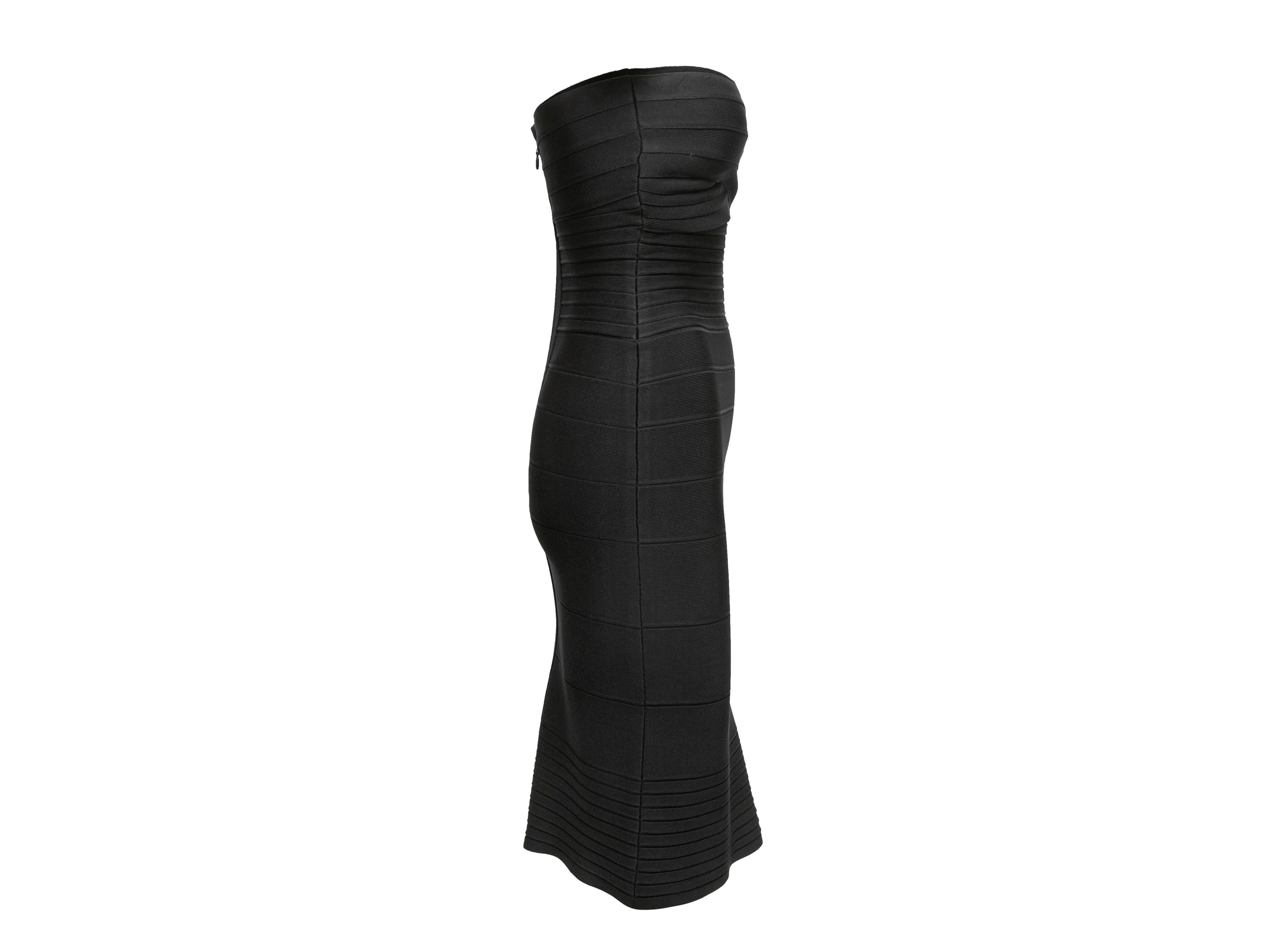Black strapless bandage dress by Herve Leger. Sweetheart neckline. Zip closure at back. 24