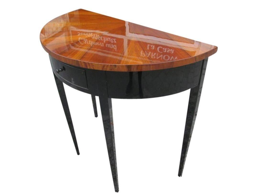 This high gloss polished, stellar veneered console features a Biedermeier Style design and stunning quality. The four conical legs are painted with high glossblack lacquer. The furniture is a perfect reproduction from the Biedermeier period.

Also
