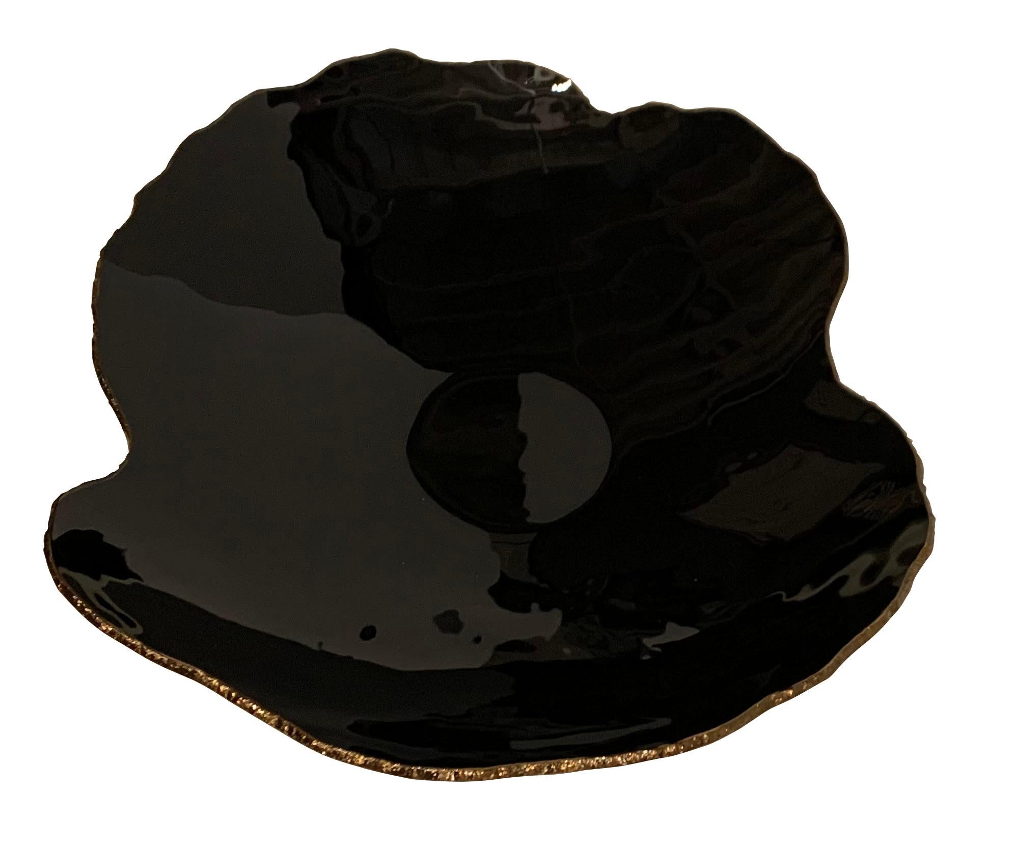 Contemporary Brazilian free form shaped high gloss black glass bowl. 
Chiseled rough edges in gold color.
One of several pieces from a large collection of Brazilian designed glass objects.