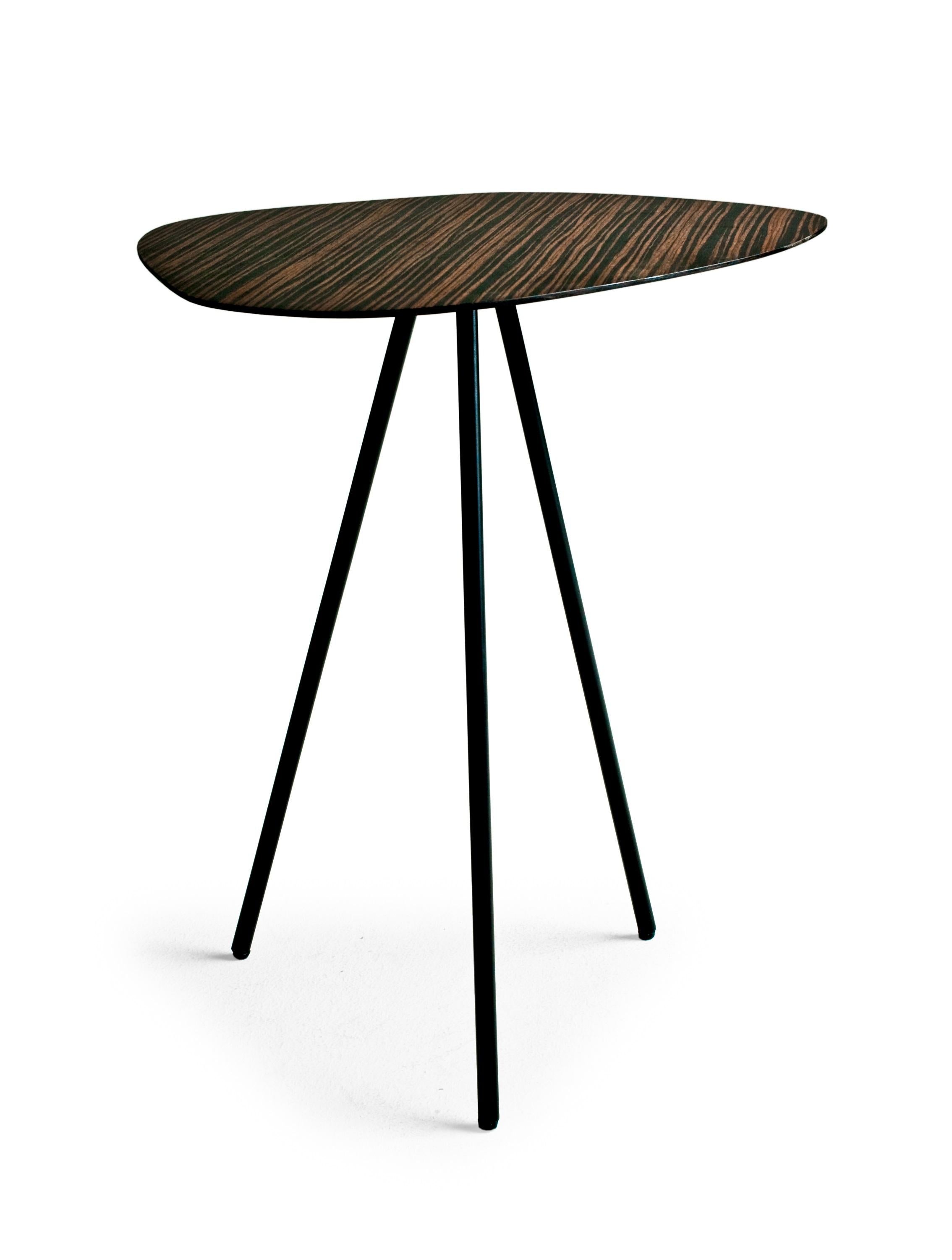 Black high indoor pebble end table by Kenneth Cobonpue.
Materials: black sapele steel. 
Also available in other colors and for indoors.
Dimensions: 36 cm x 47 cm x H 50 cm 

Pebble playfully echoes shapes found in nature like stepping-stones in
