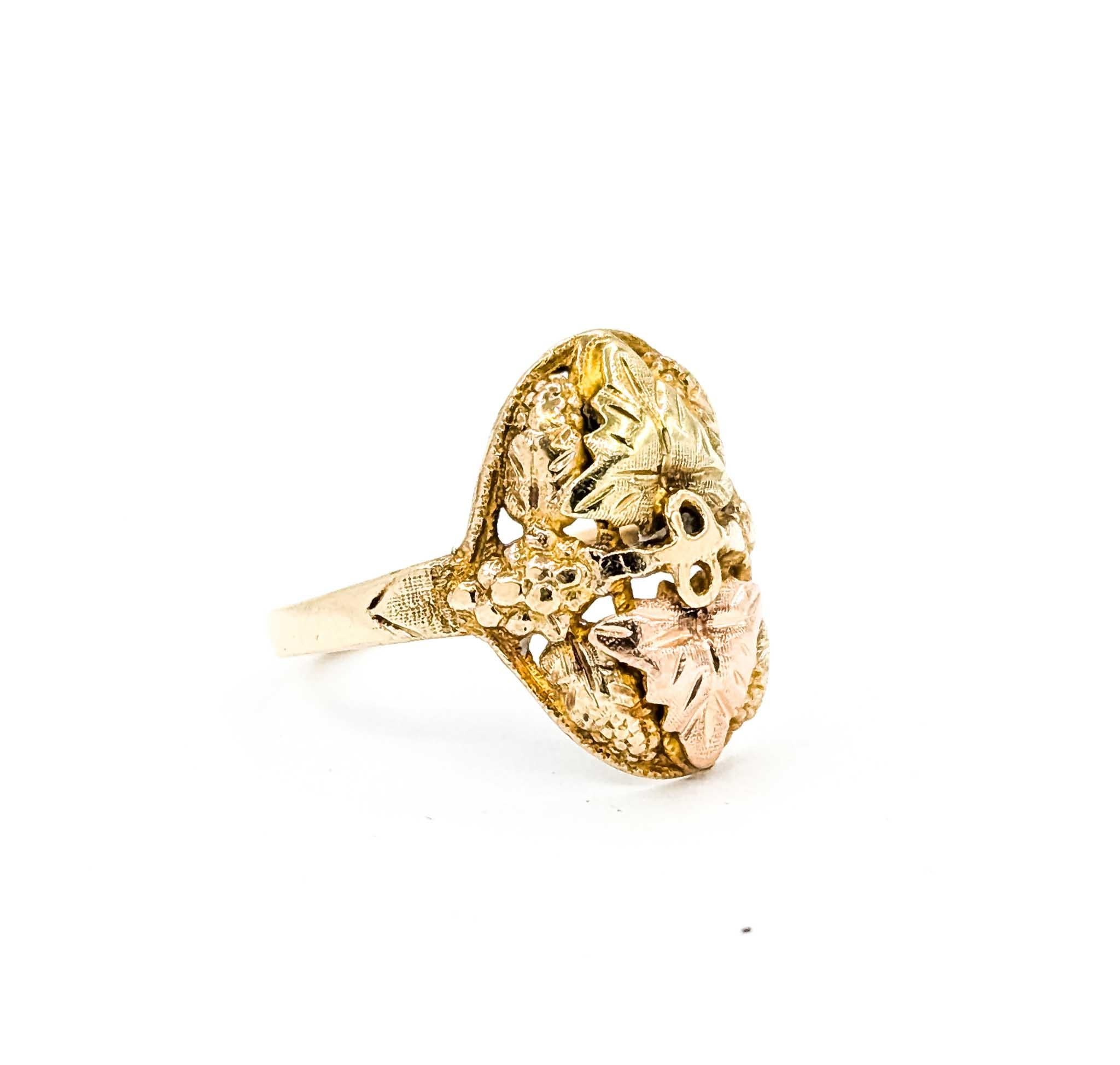 This beautiful Black Hills Gold ring features the signature tri-color leaf motif in 10k yellow, rose, and green gold. The intricate design showcases textured grape clusters and detailed leaves symbolizing love, friendship, and fidelity.

The ring