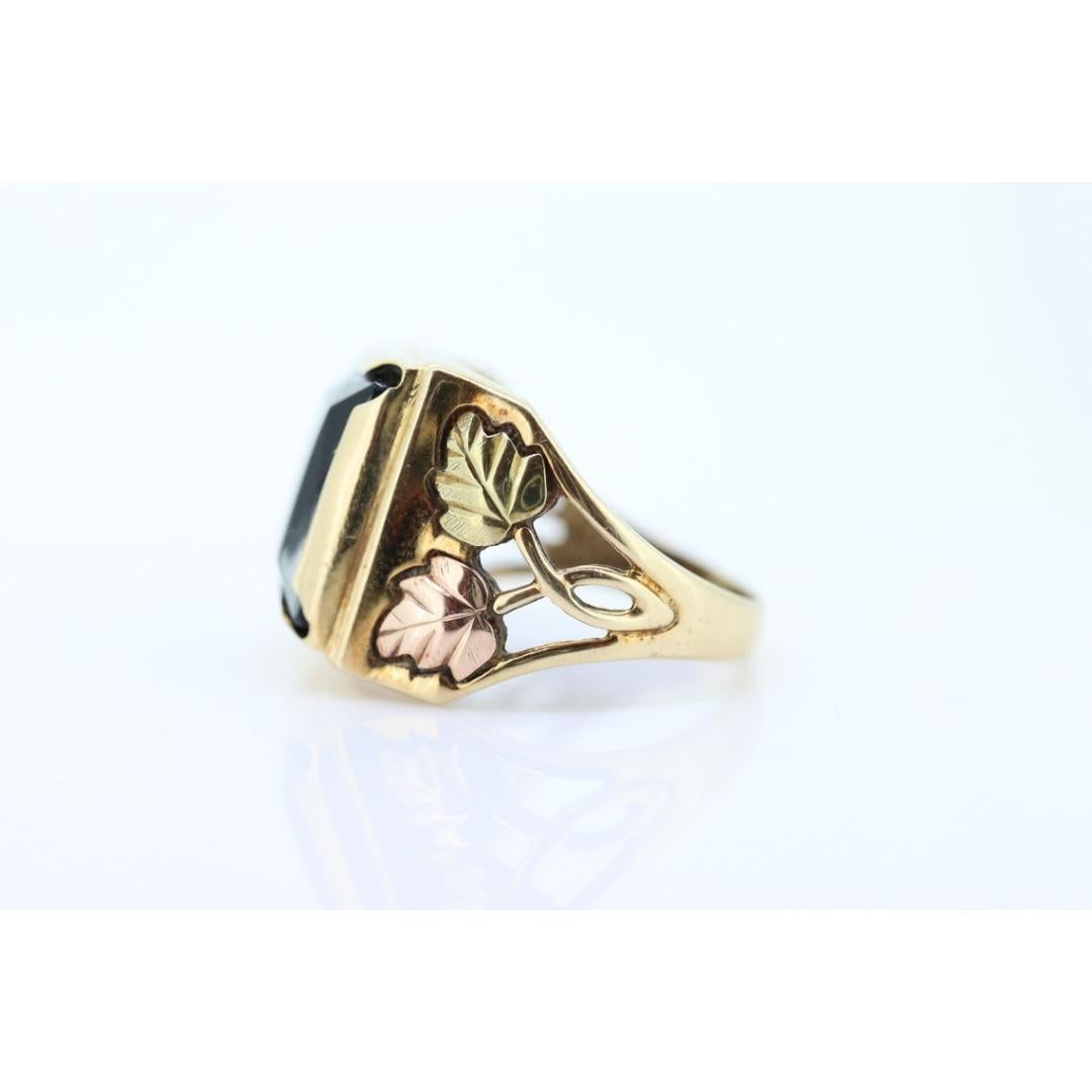 Vintage
Size: 10 1/4 US
Materials: Gold
Gemstone: Onyx
Gem color: Black
Band color: Gold

Style: Art nouveau

Rare Large and Heavy Hematite and Diamond Black Hills Gold ring. 10k Multi-tone gold. Large Size.

Details:
Sz10.25
6.8 grams total