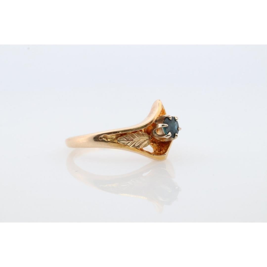 Vintage
Materials: Gold, Rose gold, White gold
Gemstone: Sapphire
Gem color: Blue
Band Color: Gold

Style: Minimalist

Black hills gold band multicolor design. Bypass design with a round blue sapphire in the center.

Size 8.5

3.5 grams
4mm Blue