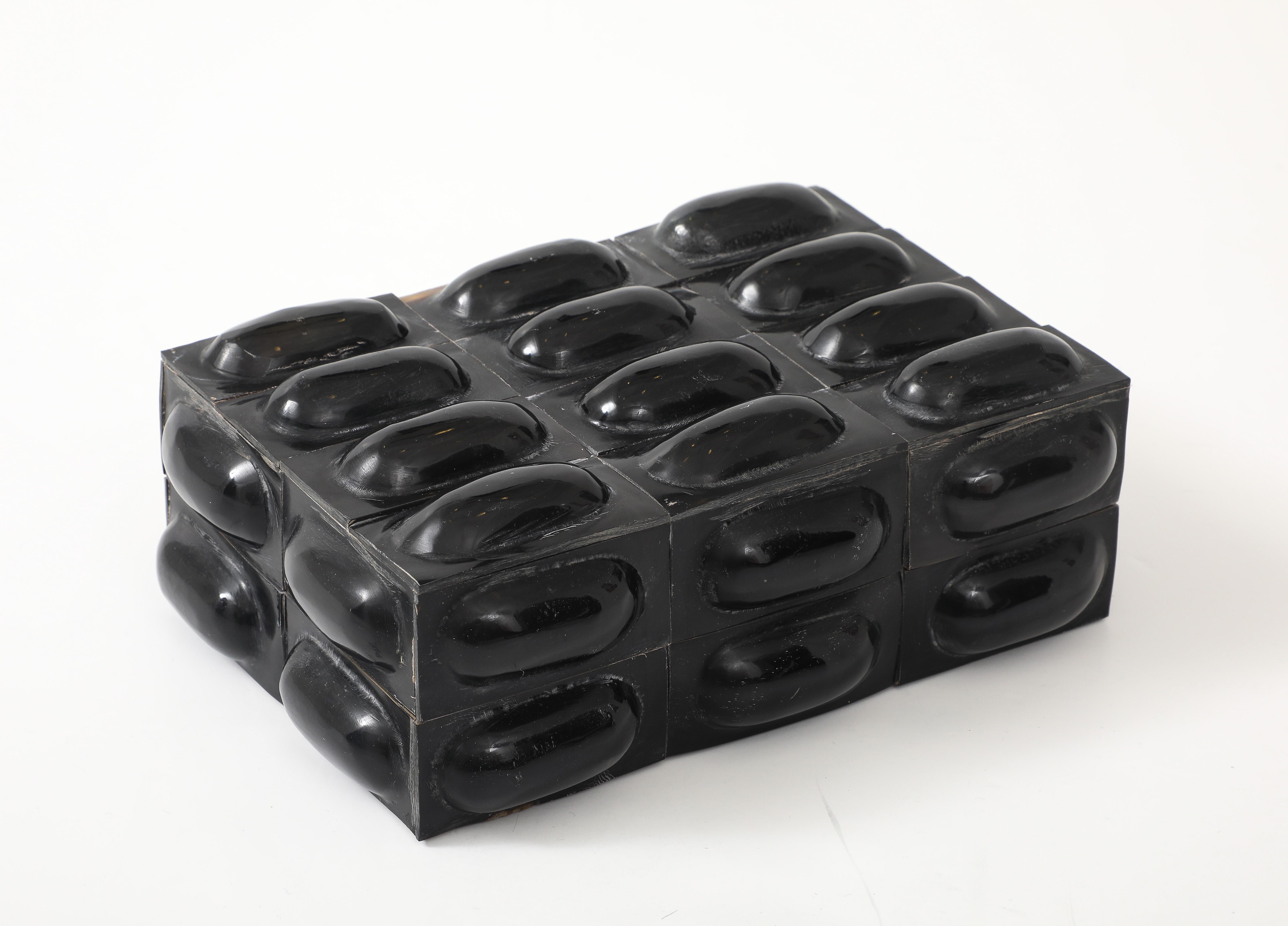 Chic keepsake/desk box clad in black horn tiles with a central convex oval. 