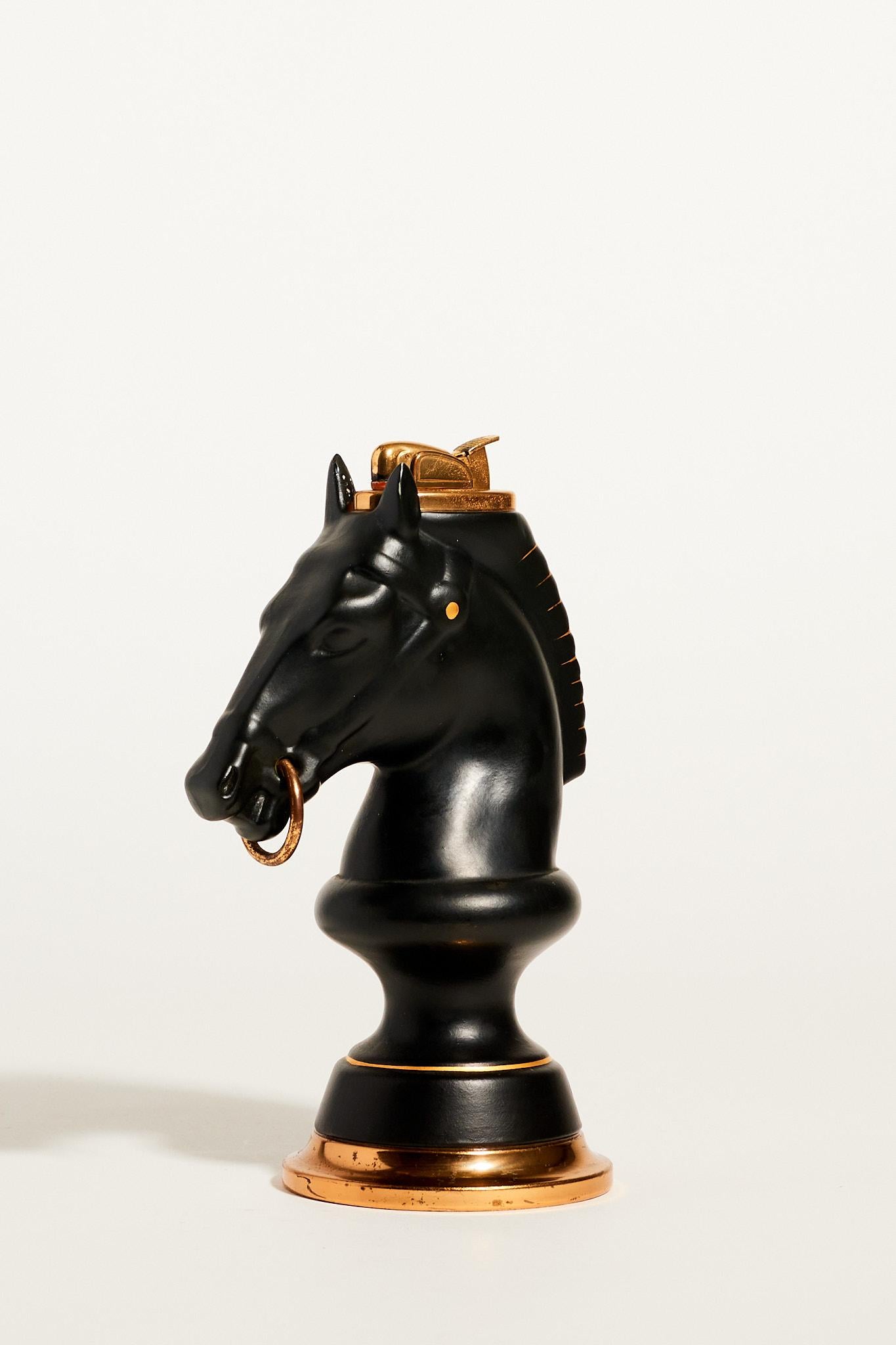 Mid century black trojan horse lighter with gold details.

*Lighters cannot be shipped with fluid inside because it is considered a hazardous material, but we have taken the lighter in to get checked and were told it could be in working condition