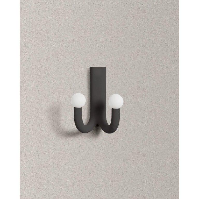 Black hotel light 08 wall lamp by Hot Wire Extensions
Materials: Waste SLS 3D nylon powder, sand from sustainable sources
Dimensions: H 39 x W 22 x L 32 cm

Other colours available: lemon, cream, aqua, grey, anthracite, pink

All our lamps can be