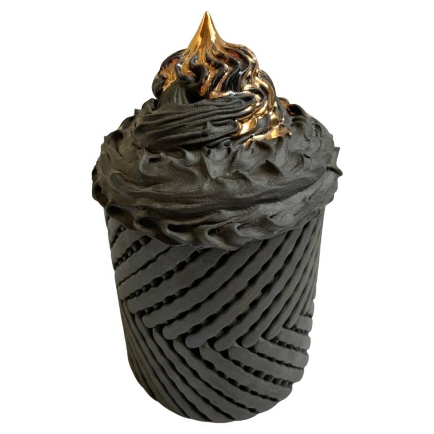 Is it a volcano erupting, or is it icing on a cake, it's all in the eye of the beholder. Theres a lot going on with this little sculpture, the base has a lattice weave design, with strands resting on the surface, then switching at mid point to
