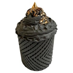 Chocolate Icing Topped with Gold Syrup on Circular Lattice Body