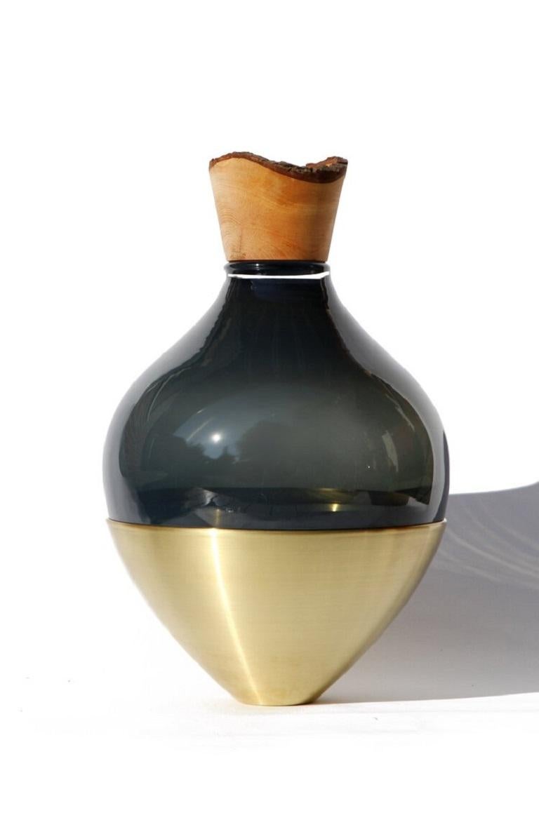 Black India vessel II, Pia Wüstenberg.
Dimensions: D 20 x H 38.
Materials: glass, wood, metal.
Available in other metals: brass, copper, brass patina, copper patina, rust.

Handmade in Europe, by individual craftsmen: handblown glass (Czech