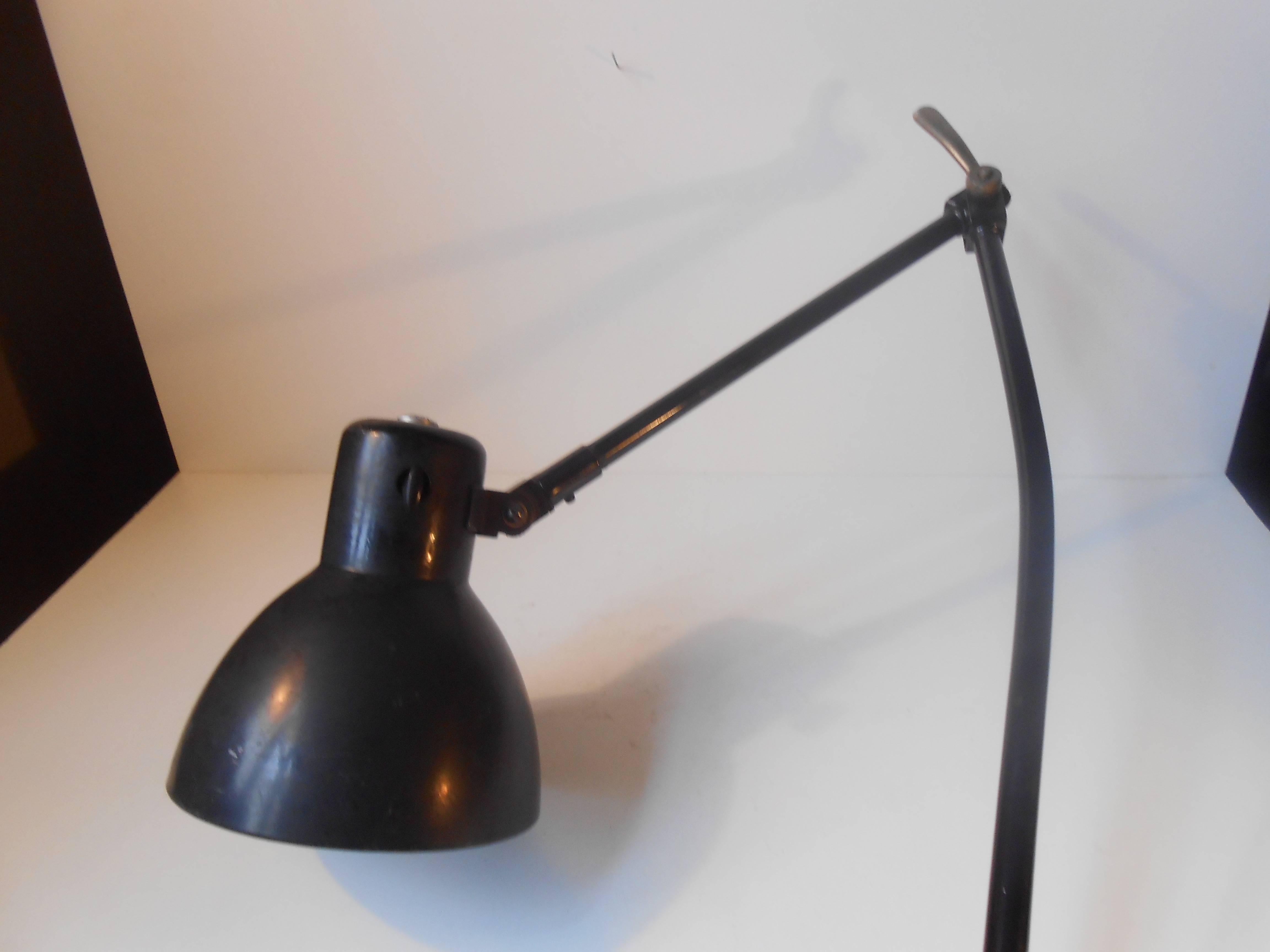 Industrial architect desk or wall light designed by Bauhaus Icon Marianne Brandt. It was manufactured by German Kandem in the 1930s. The adjustable arms is made from black enameled steel and the shade dfrom enameled aluminium. It has a large