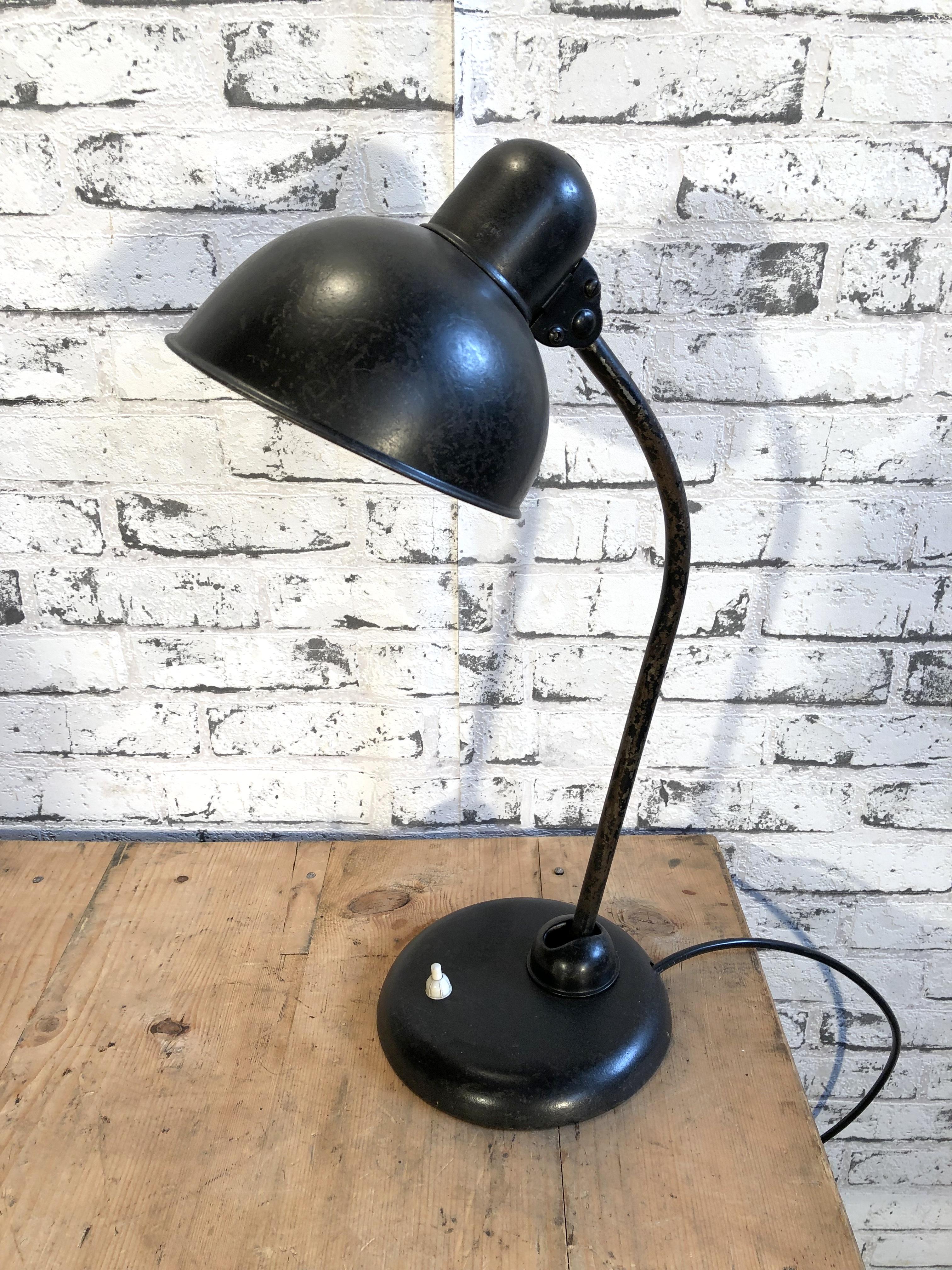 This black Bauhaus industrial desk lamp was made during the 1930s. Lamp has black metal shade, iron base with two adjustable joints and original socket for E 27 bulbs. New wire.
