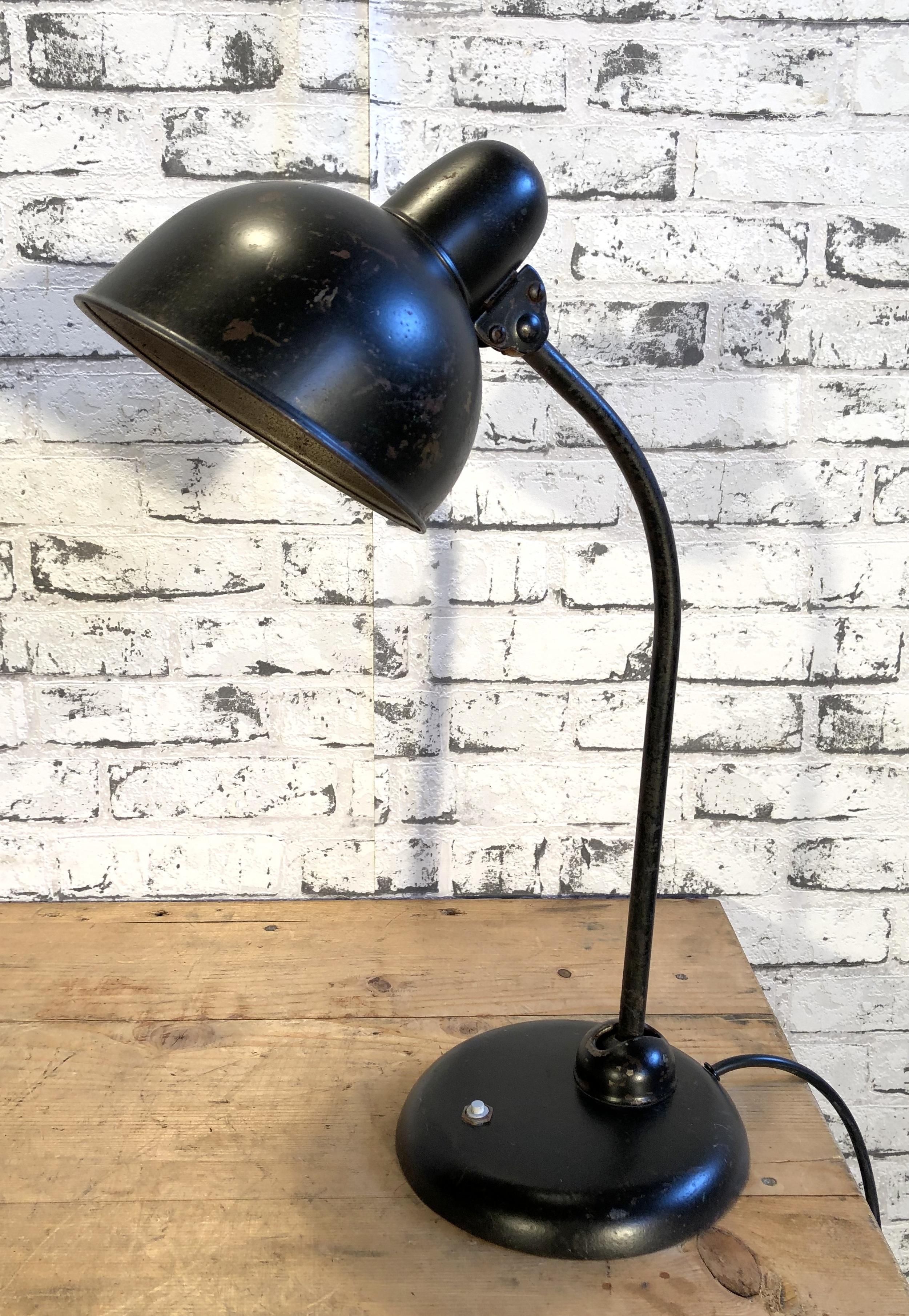This black Bauhaus industrial desk lamp was made during the 1930s. Lamp has black metal shade, iron base with two adjustable joints and original socket for E 27 bulbs. New wire.