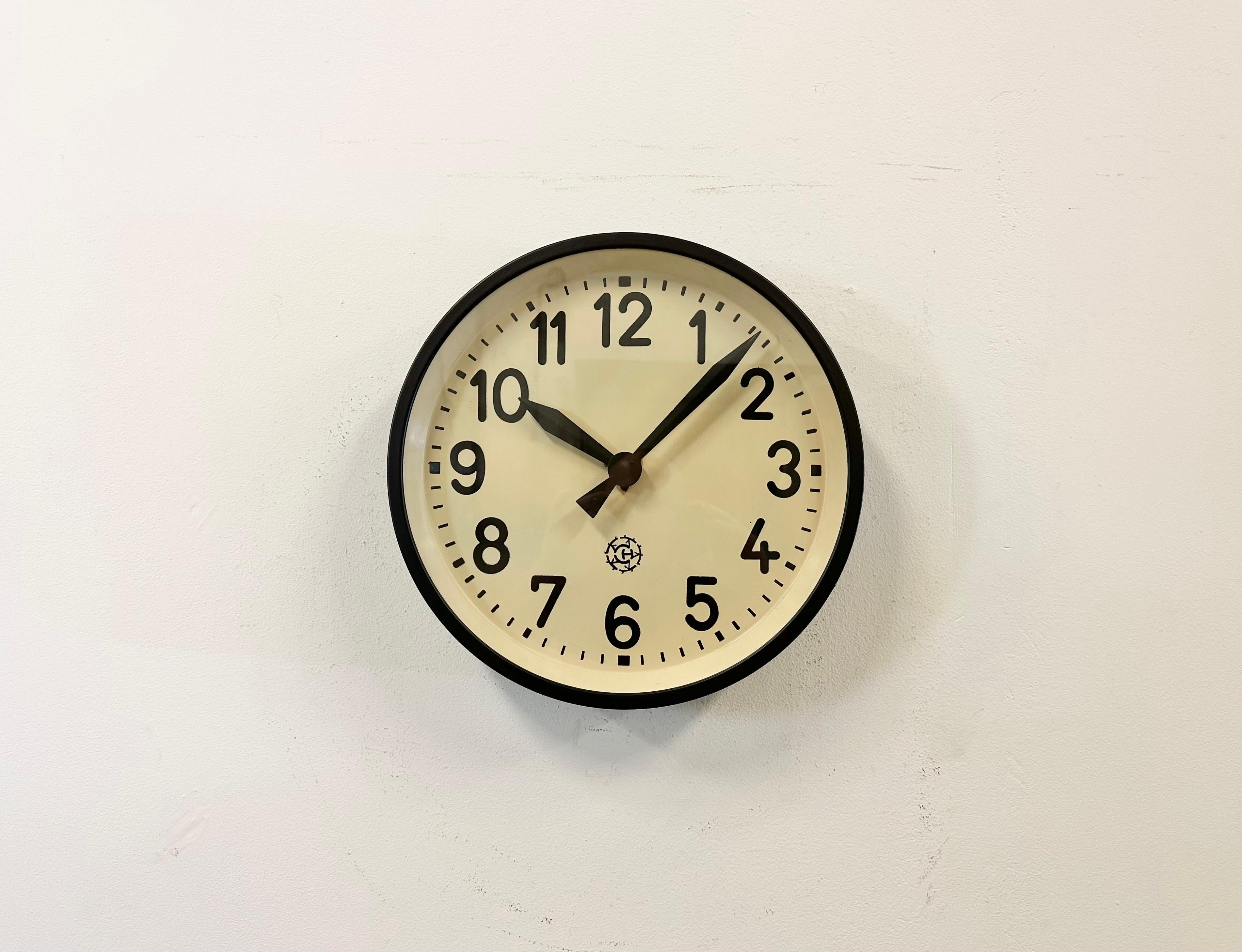This factory wall clock wad produced by Chronotechna in former Czechoslovakia during the 1950s. It features a newly painted black metal frame, iron dial, aluminum hands and clear glass cover. Former electrical slave clock has been converted into a