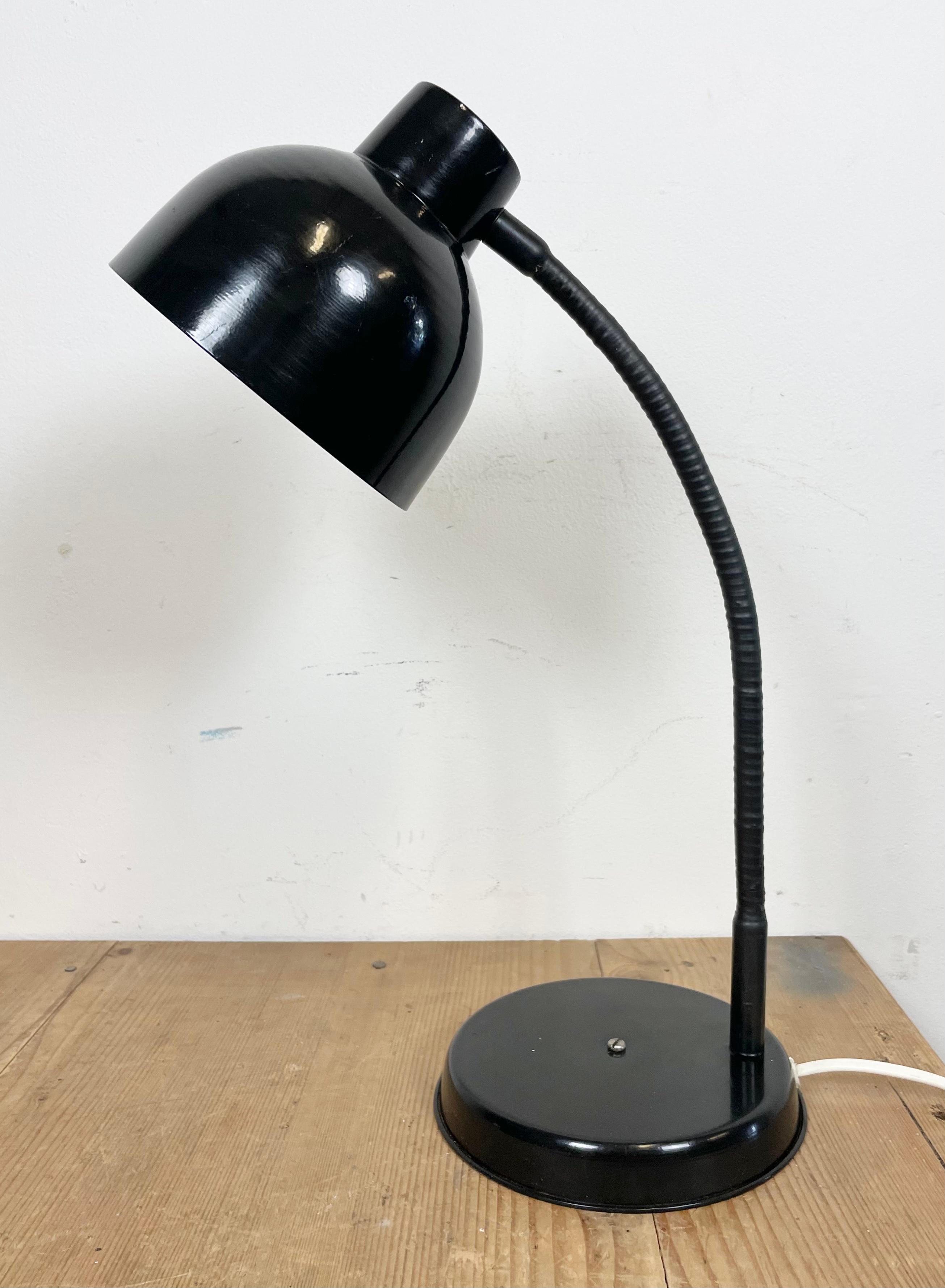 Industrial workshop table lamp made in Poland during the 1960s.It features a black metal base and shade and a black ruberized gooseneck. The original socket requires E27/E26 lightbulbs.
The diameter of the shade is 15 cm. Fully functional.