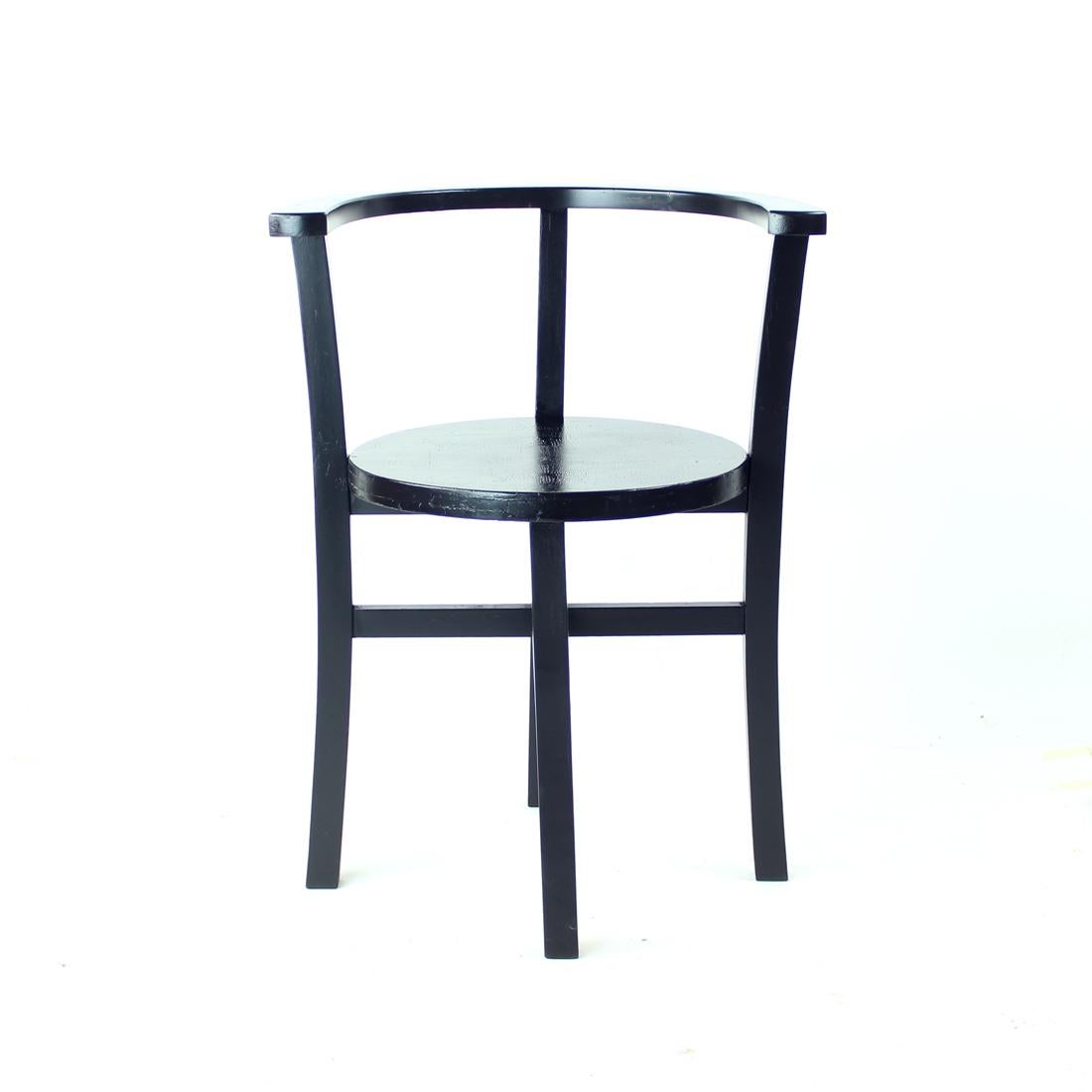 Beautiful chair produced in Czechoslovakia in 1930s, in the between war period. The chair is completely restored into a matt black finish. Originally produced from oak wood with a beautiful design of curved back and round seat. The design of the