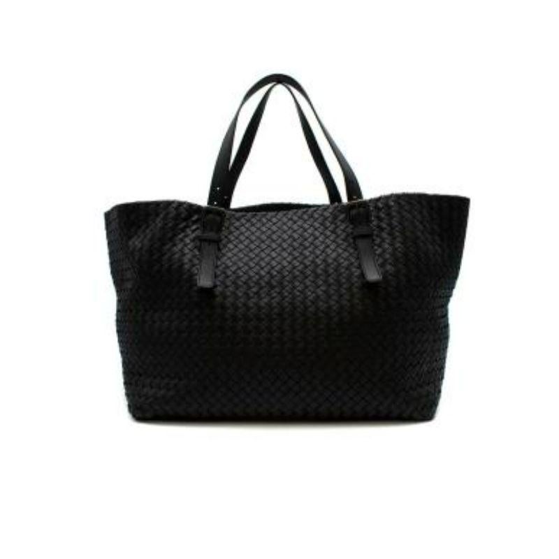 Bottega Venata Black Intrecciato leather tote bag
 
 - Soft Intrecciato woven leather body
 - Flat shoulder straps with buckle detail 
 - Open top, with brown suede lining and small zip pocket
 
 Materials
 Leather 
 
 Made in Italy 
 
 PLEASE NOTE,