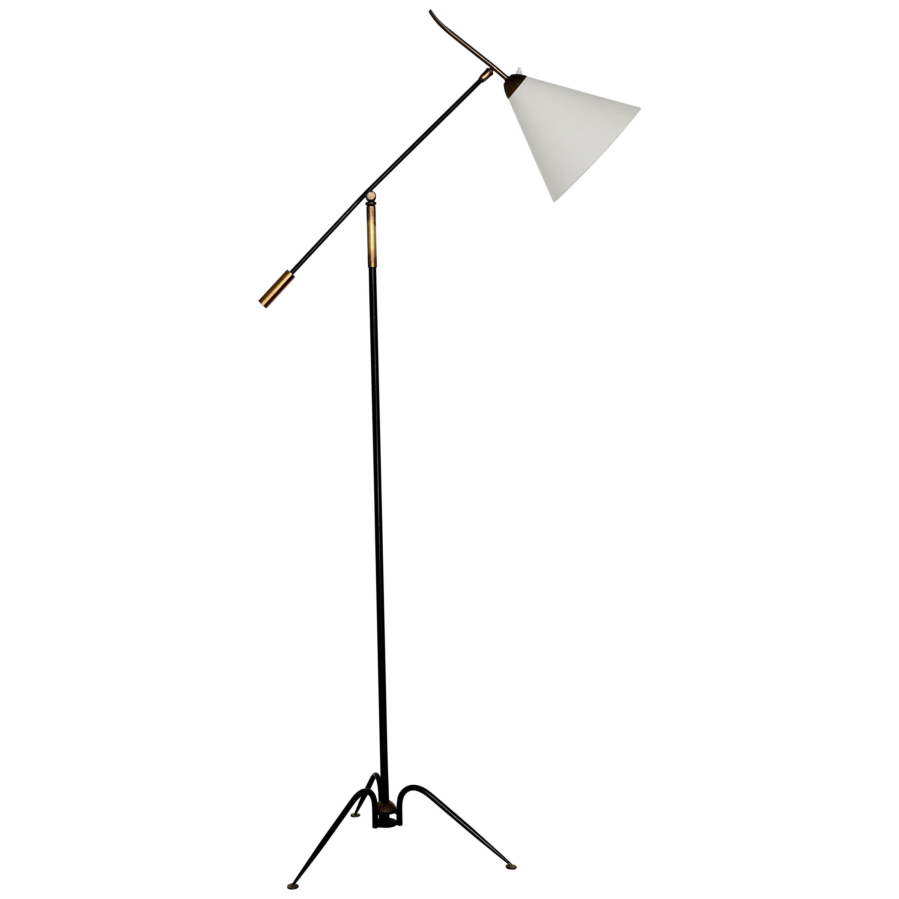 This tripod French floor lamp is made of black iron and bronze. It has an articulating arm which is adjustable as is the angle of the shade. The cone shade is new and has been rewired for use in the United States. The workmanship throughout is high